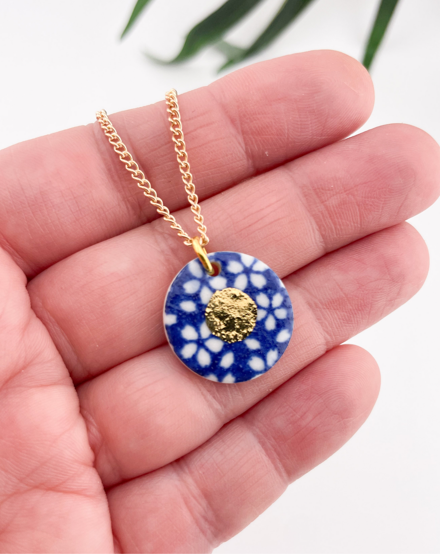 White Flower on Blue Pendant necklace with gold centre