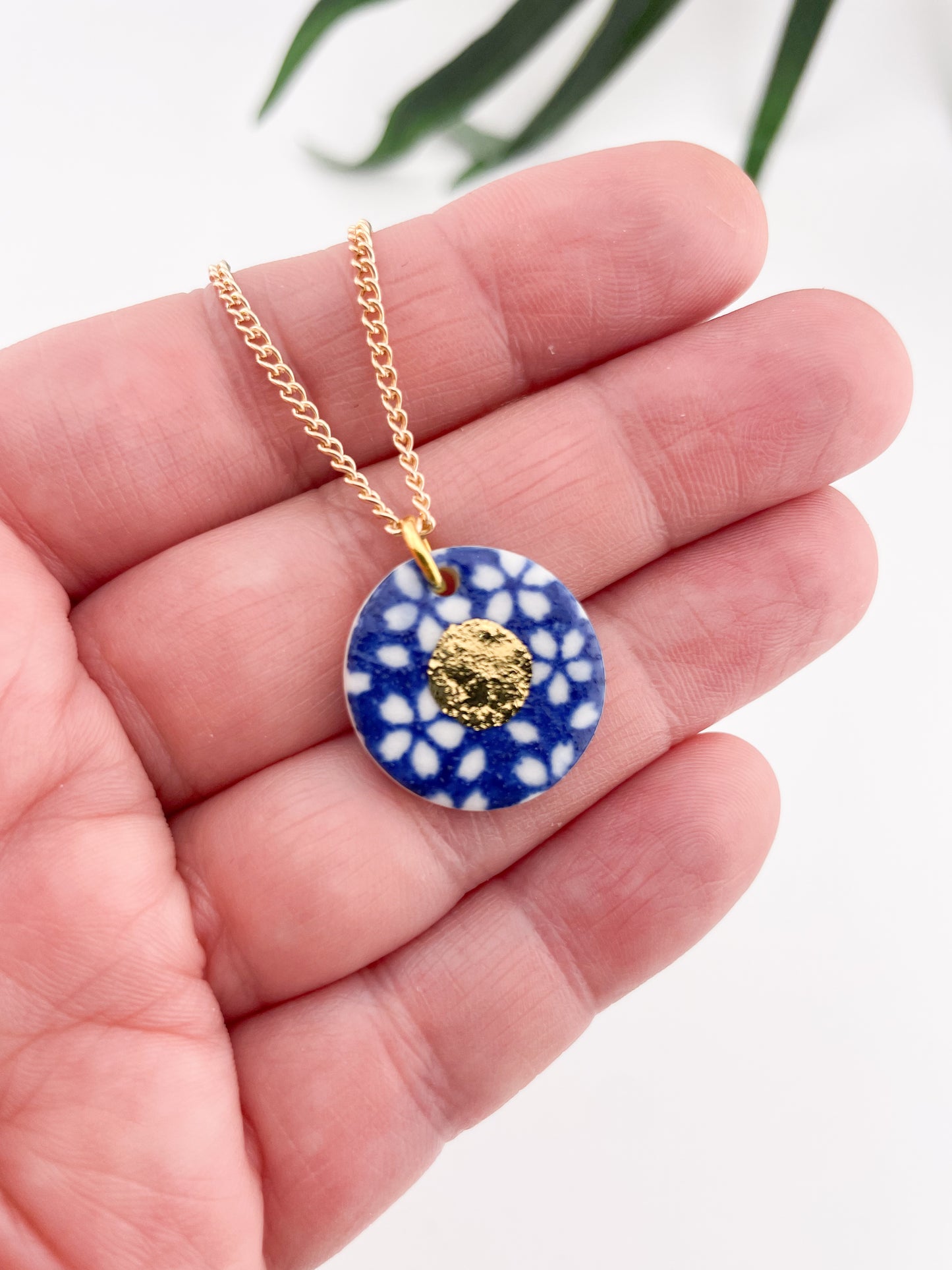 Blue Pendant with white flowers pattern & gold lustre centre