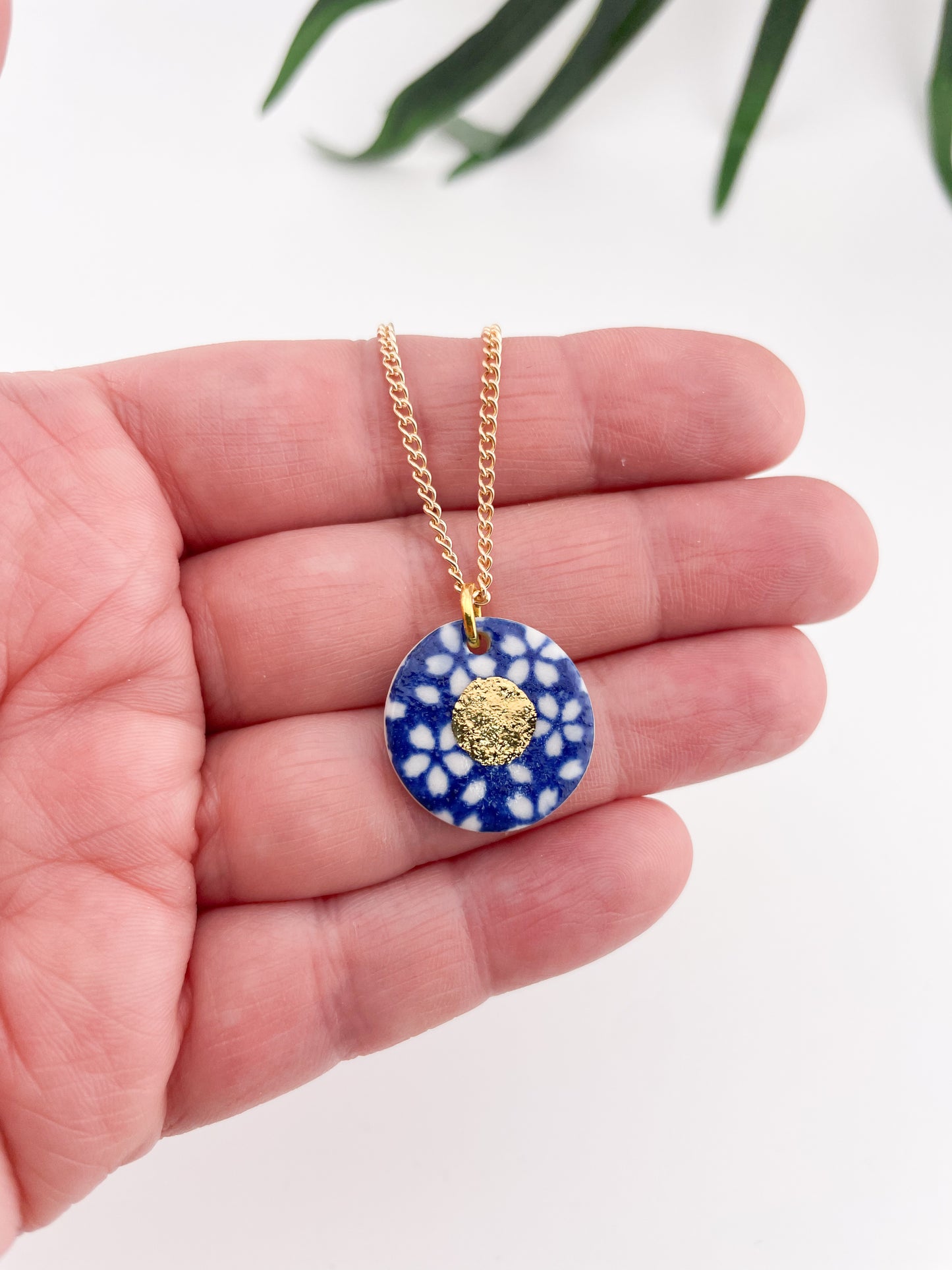 Blue Pendant with white flowers pattern & gold lustre centre