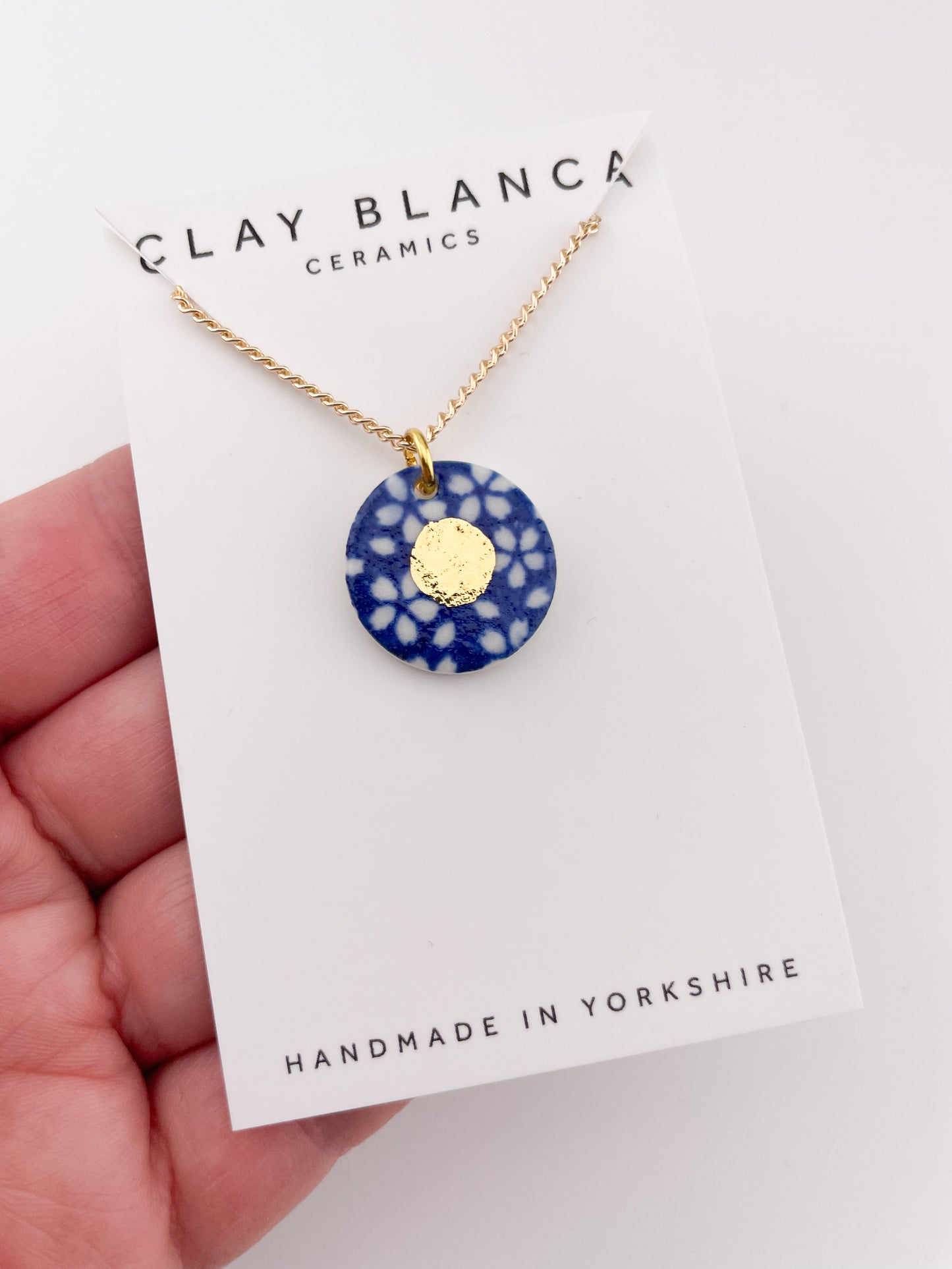 Blue Pendant with white flowers pattern & gold lustre centre