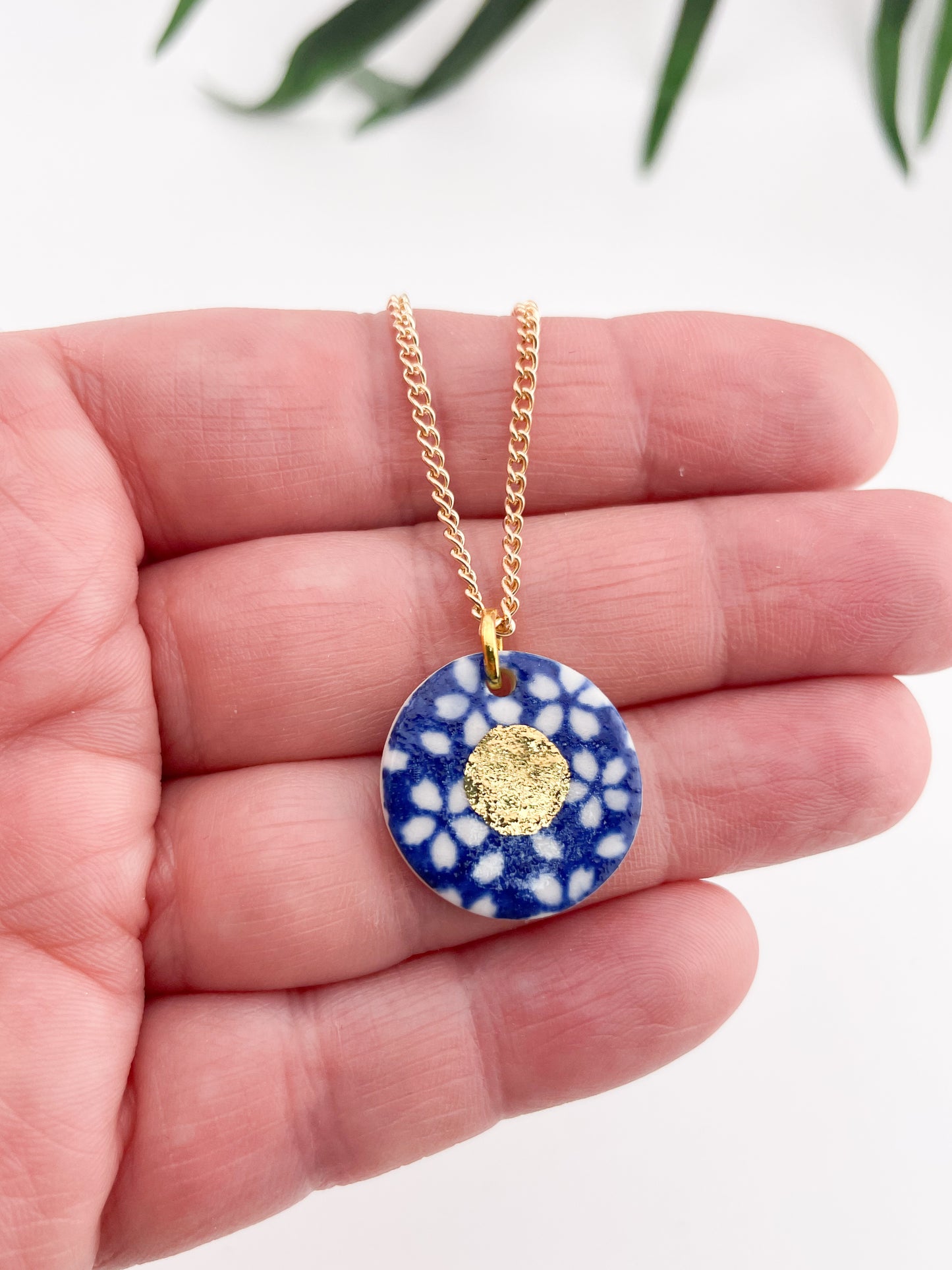 Blue Pendant with white flowers pattern & gold lustre centre