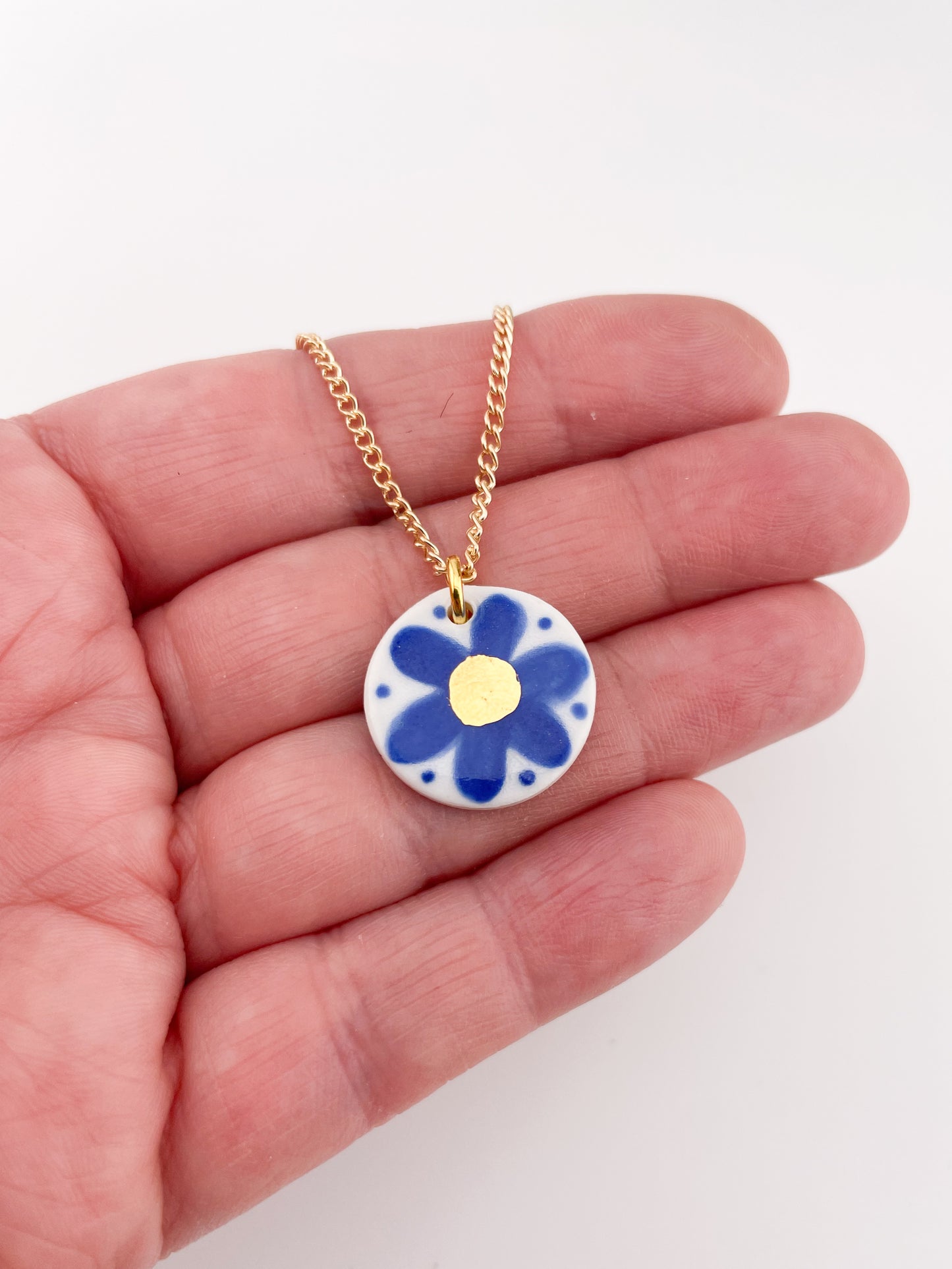 Hand painted blue flower pendant with gold centre