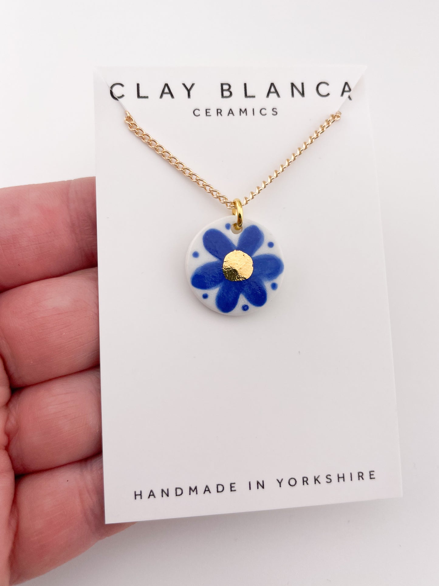 Hand painted blue flower pendant with gold centre