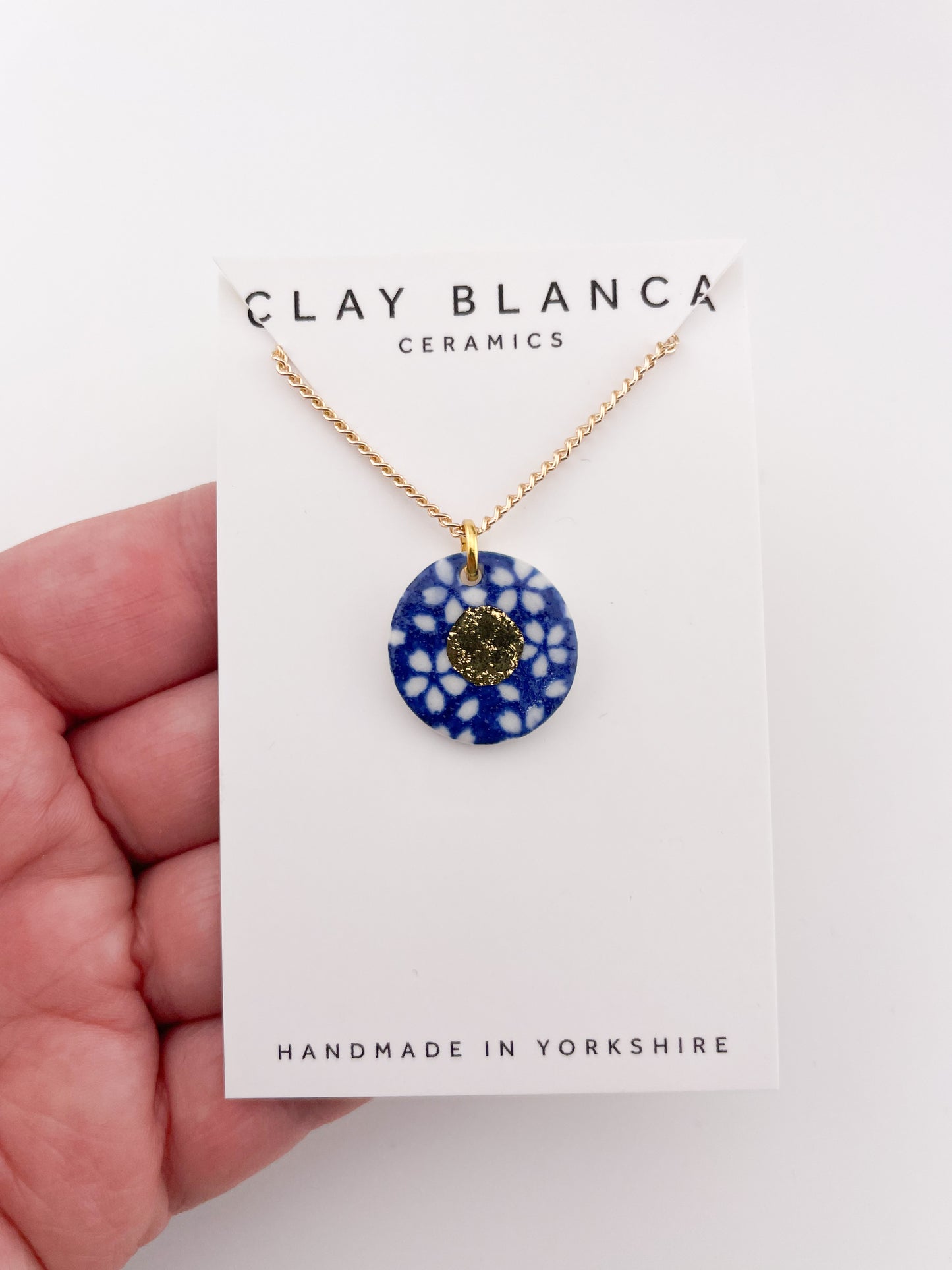 Blue Pendant with white flowers pattern & gold lustre centre