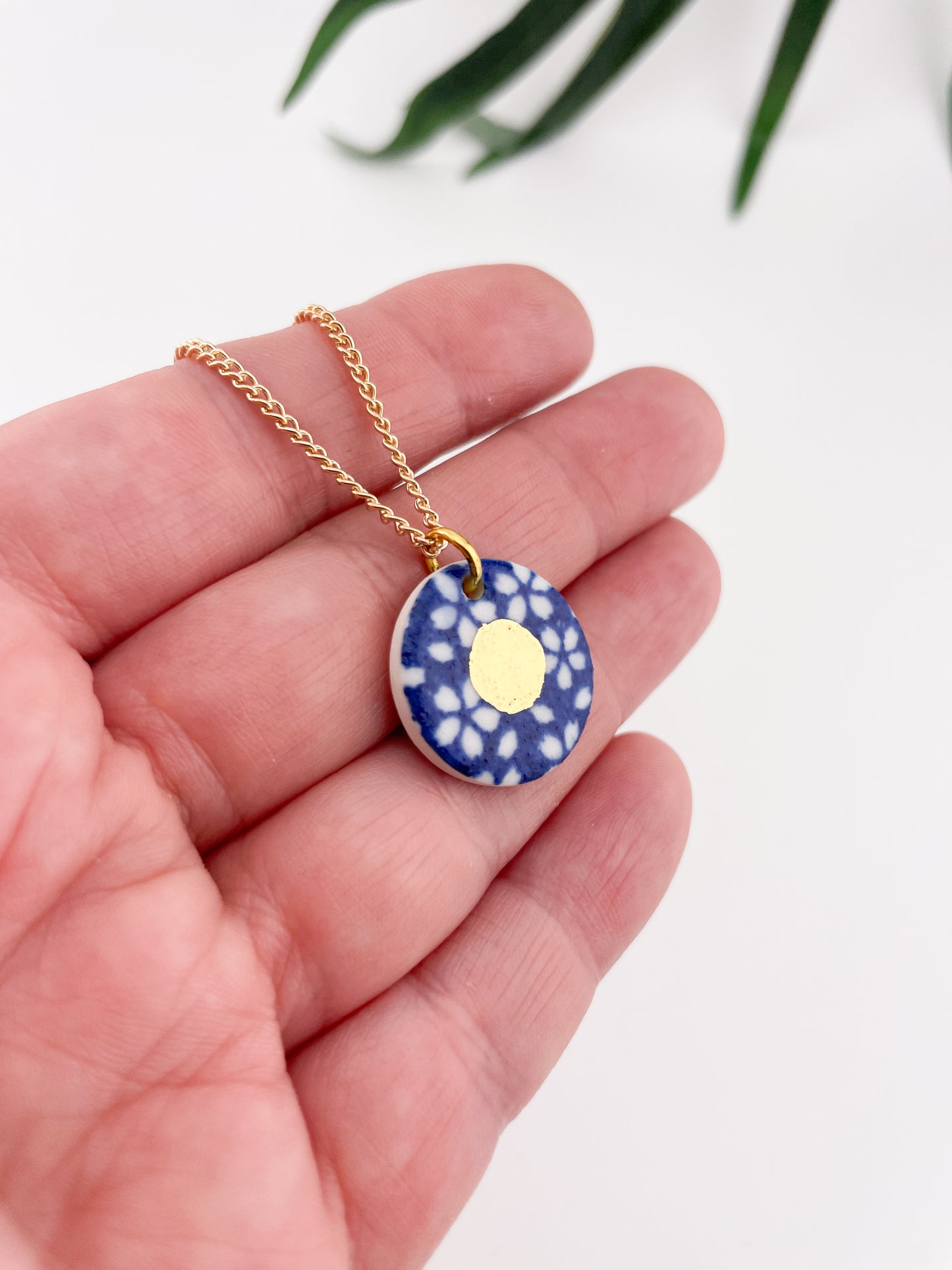 Blue Pendant with white flowers pattern & gold lustre centre