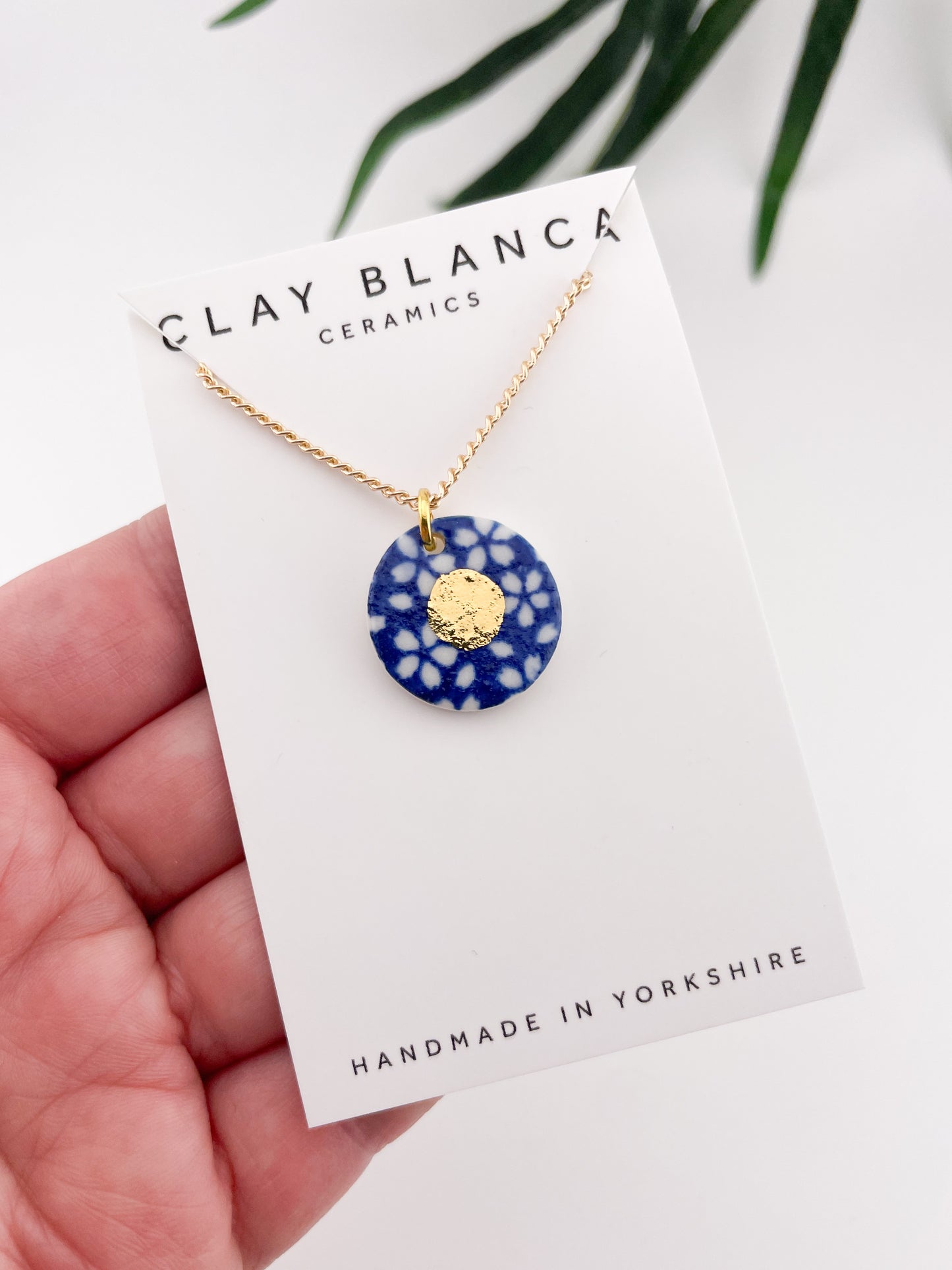 Blue Pendant with white flowers pattern & gold lustre centre