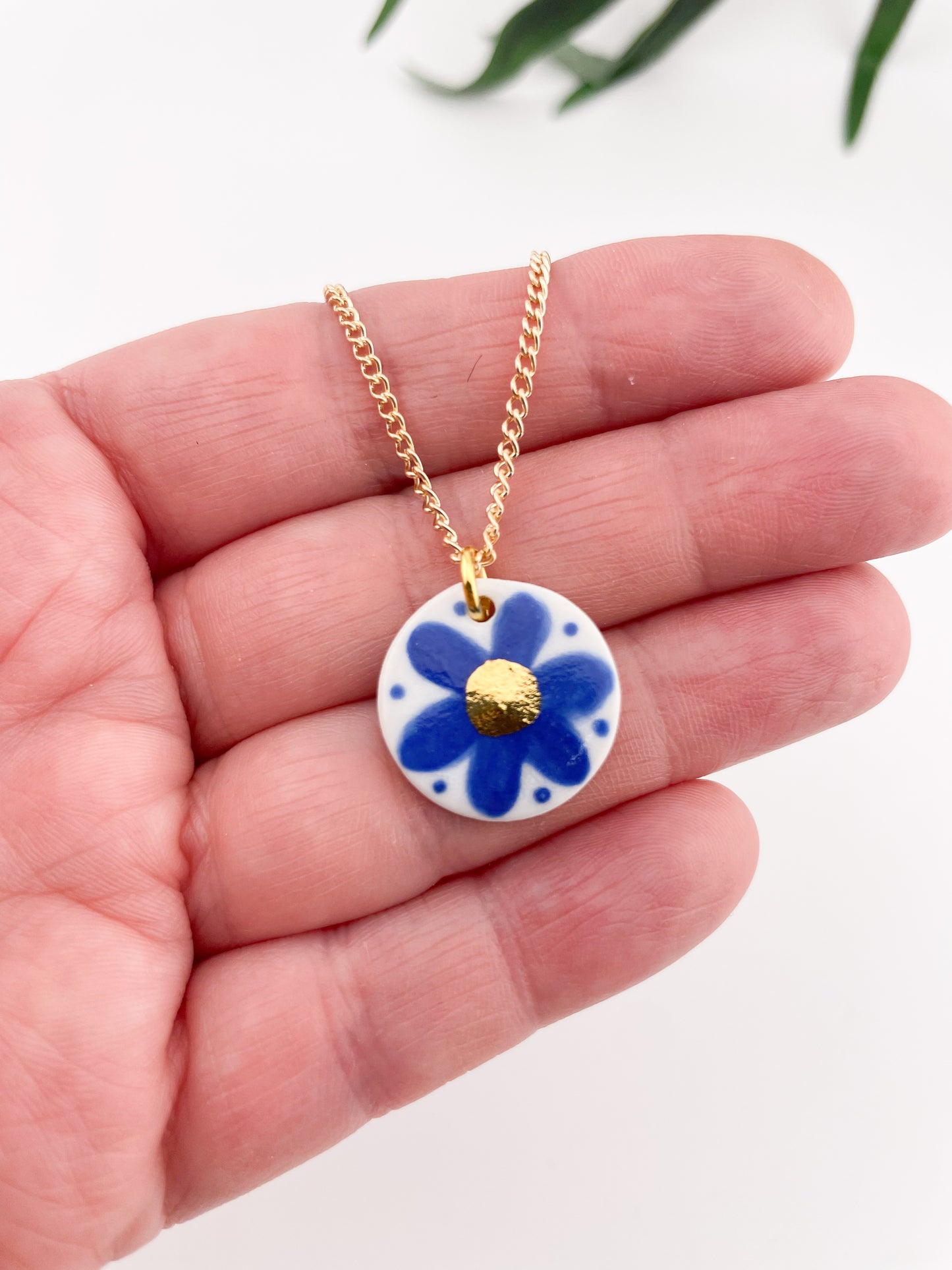 Hand painted blue flower pendant with gold centre