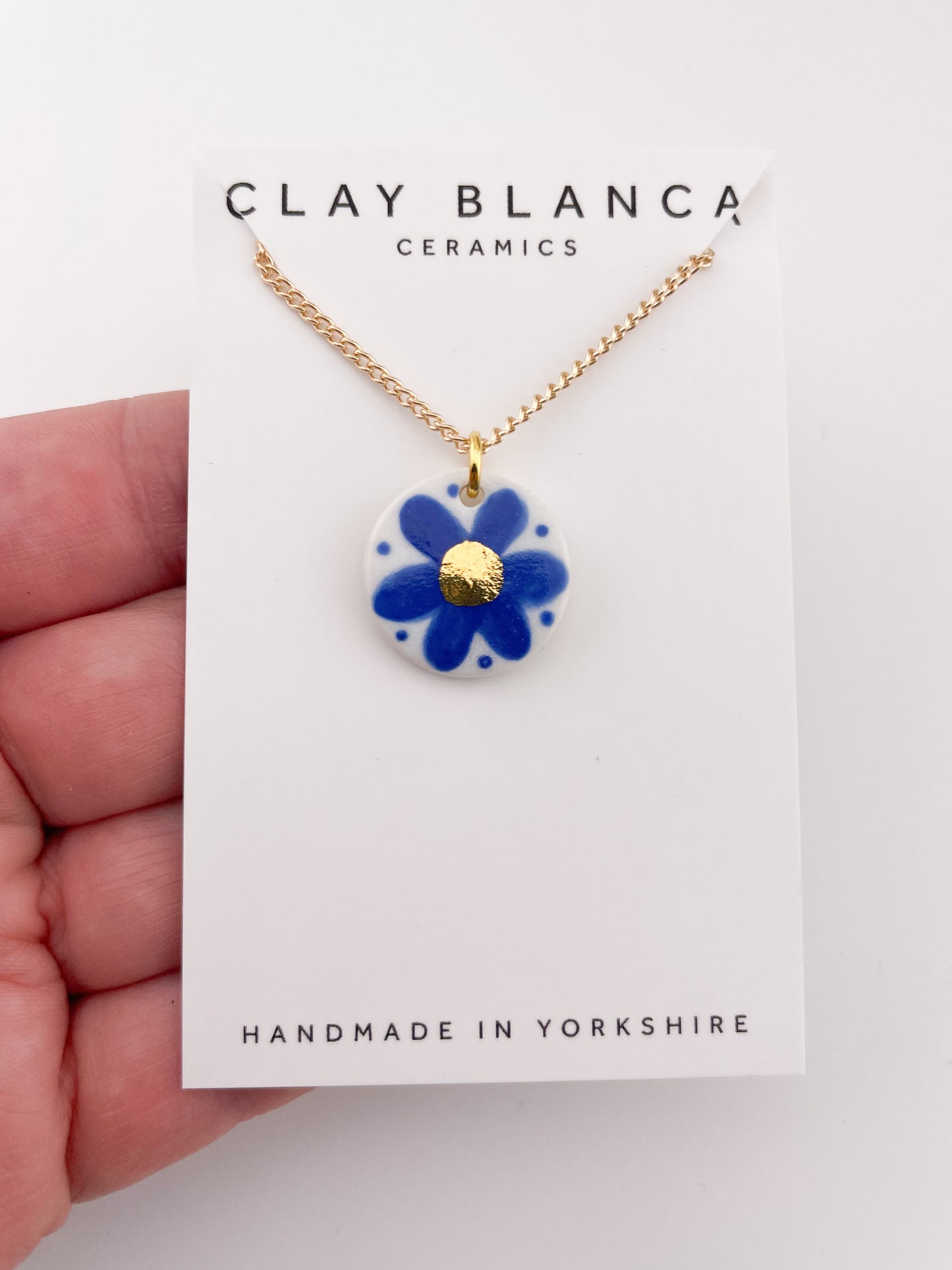 Hand painted blue flower pendant with gold centre