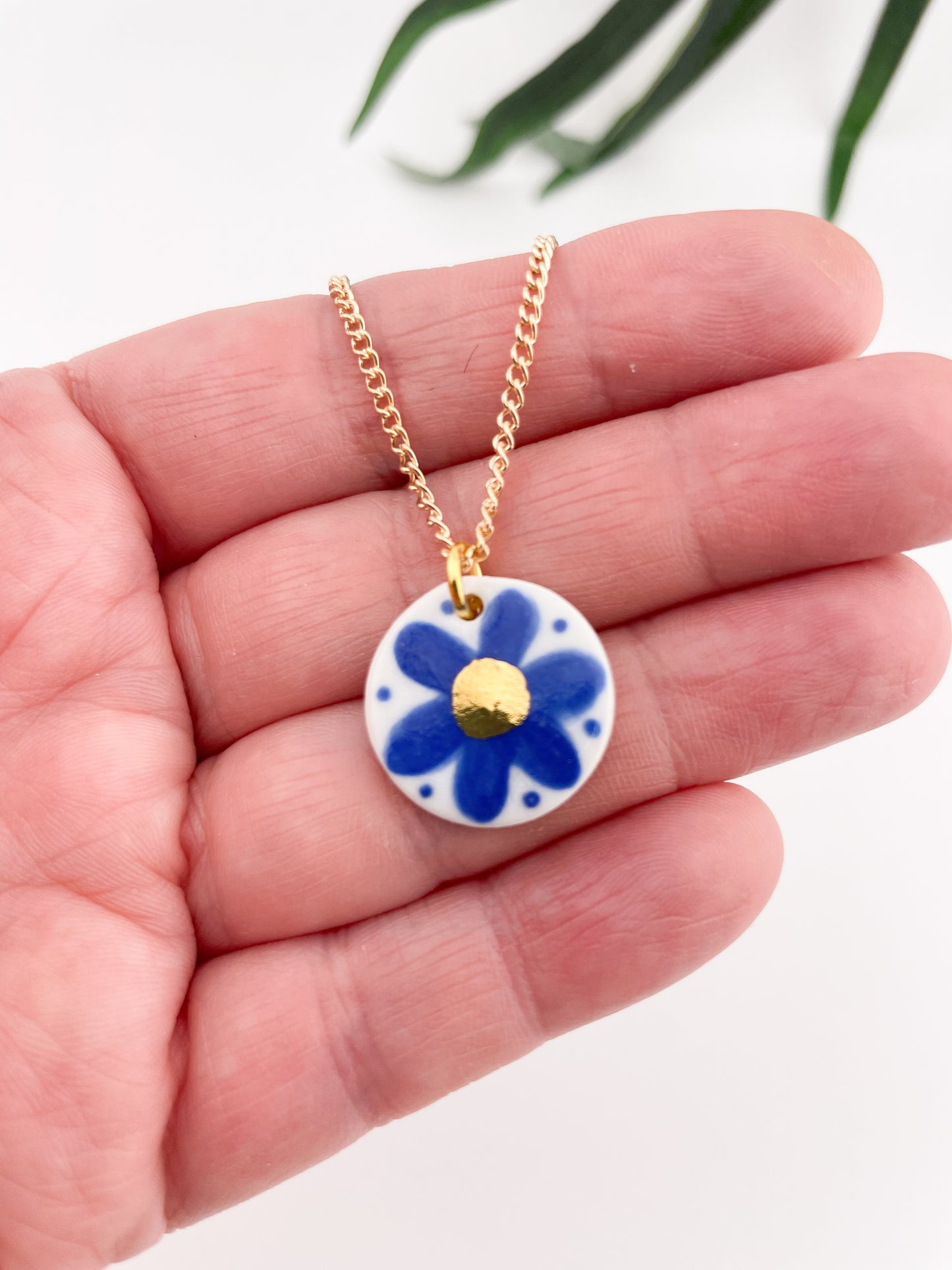 Hand painted blue flower pendant with gold centre