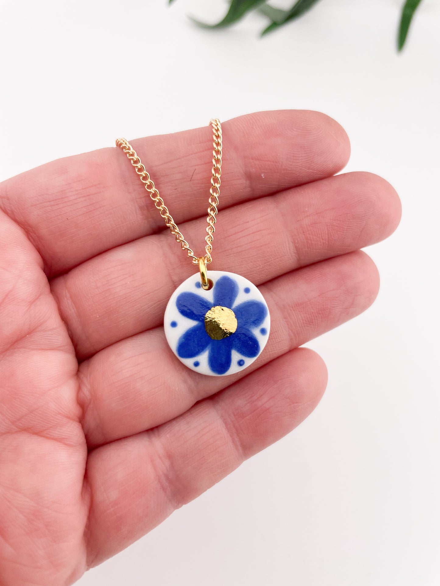 Hand painted blue flower pendant with gold centre