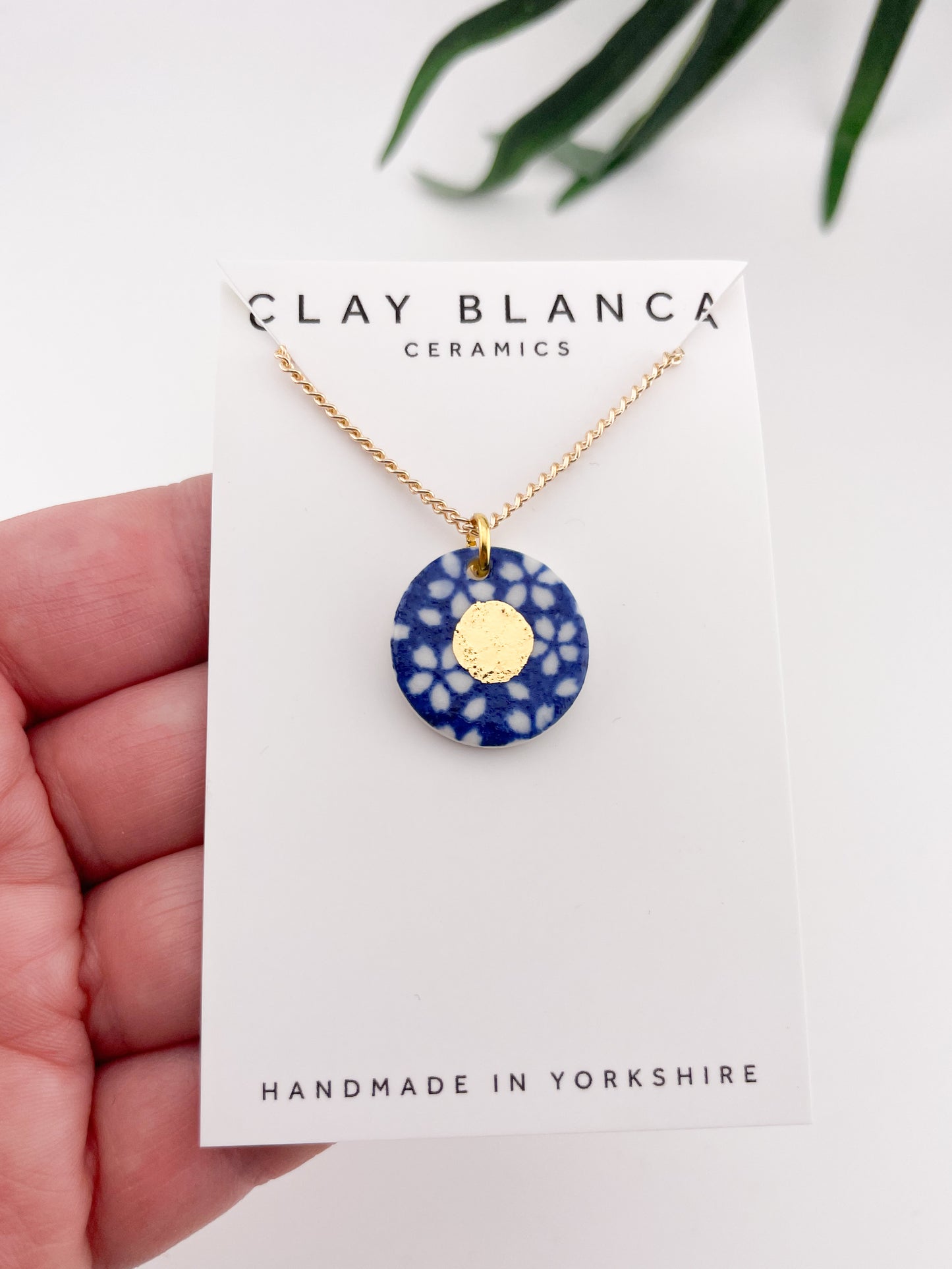 Blue Pendant with white flowers pattern & gold lustre centre