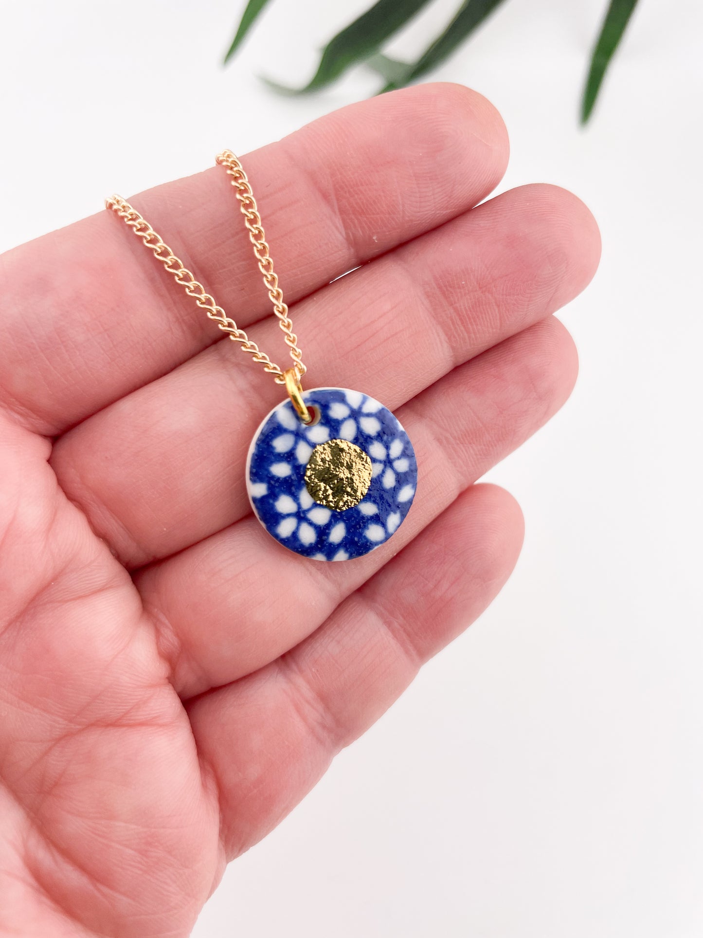 Blue Pendant with white flowers pattern & gold lustre centre