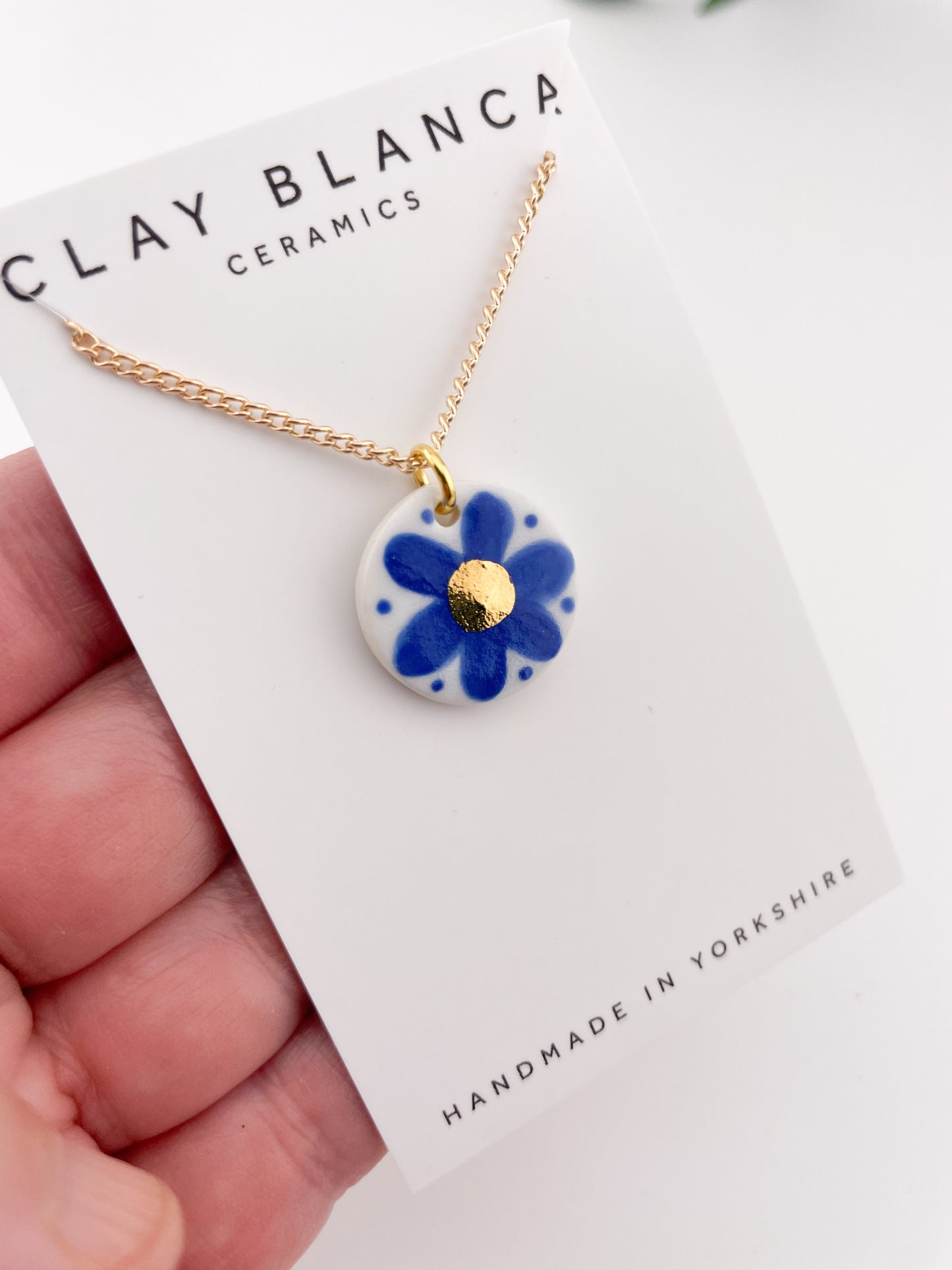 Hand painted blue flower pendant with gold centre