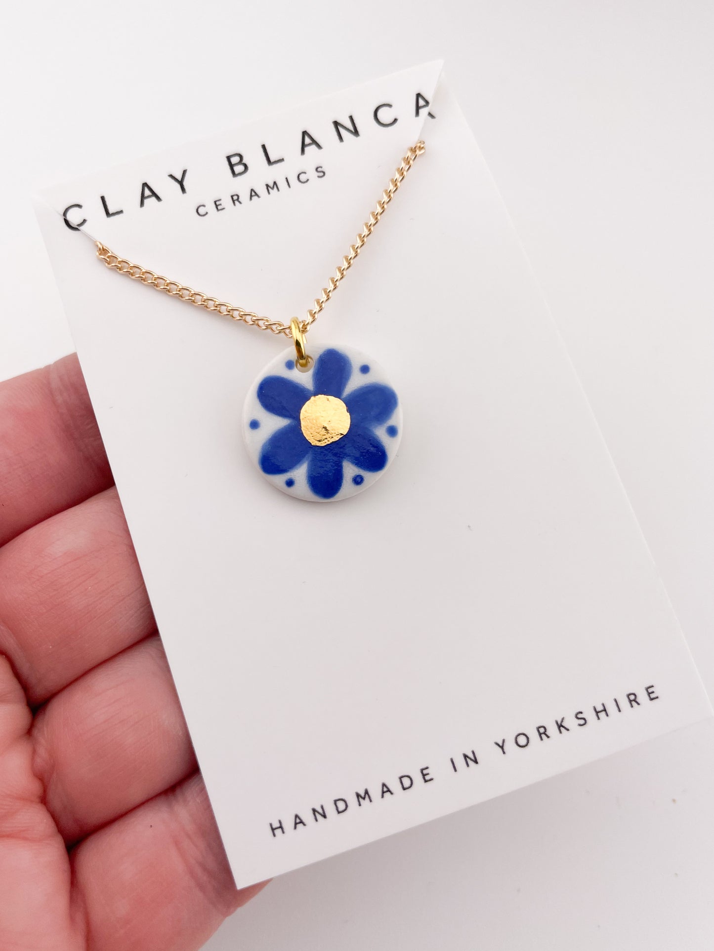 Hand painted blue flower pendant with gold centre