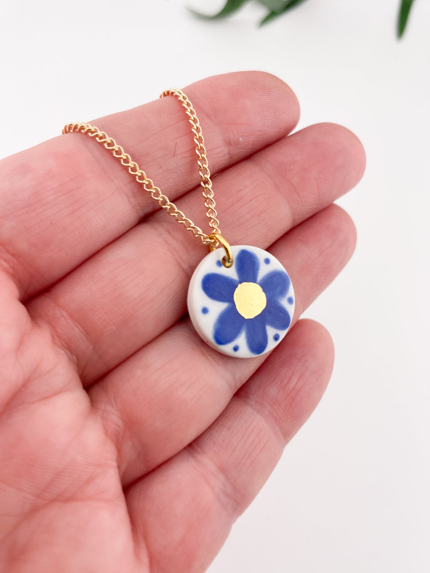 Hand painted blue flower pendant with gold centre