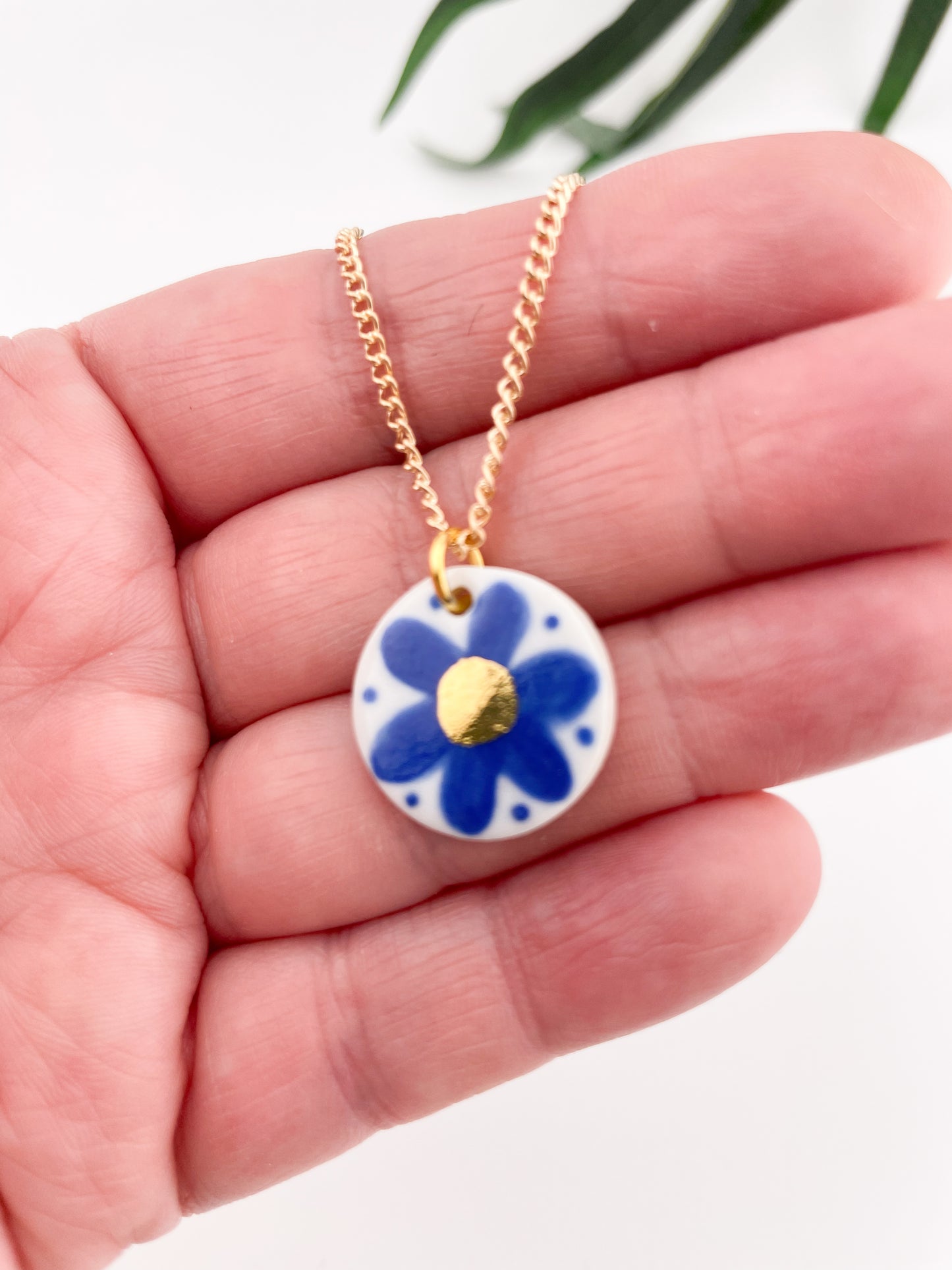 Hand painted blue flower pendant with gold centre