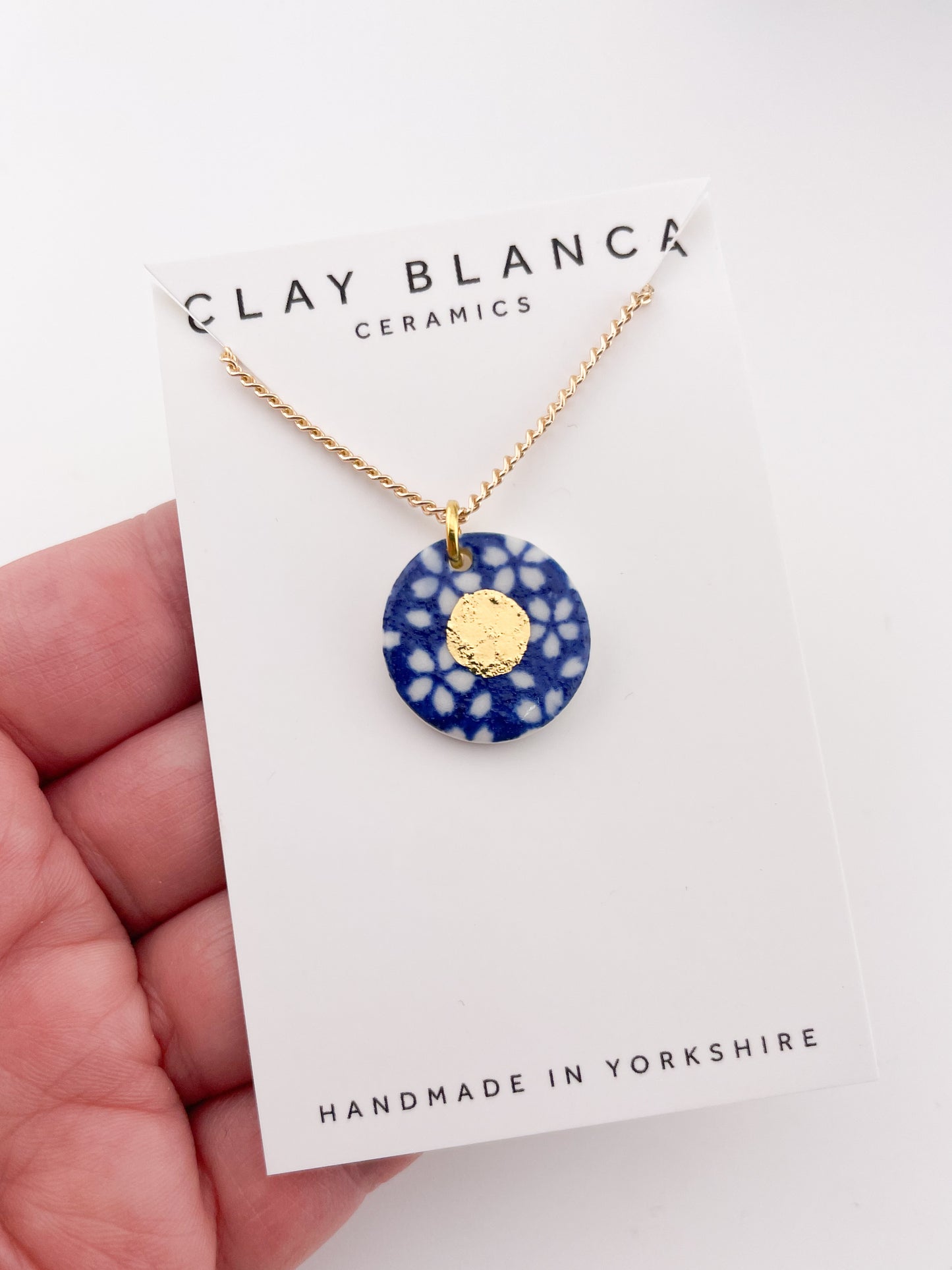 Blue Pendant with white flowers pattern & gold lustre centre