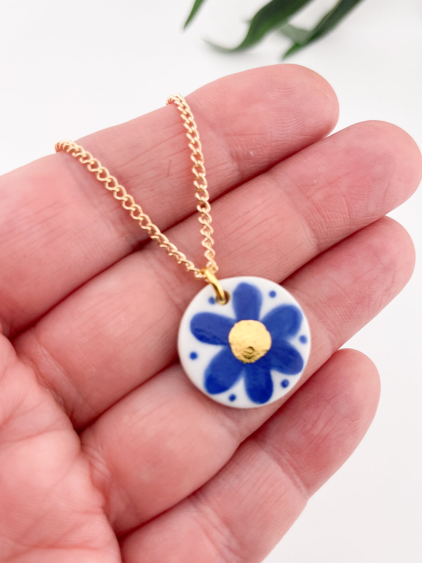 Hand painted blue flower pendant with gold centre