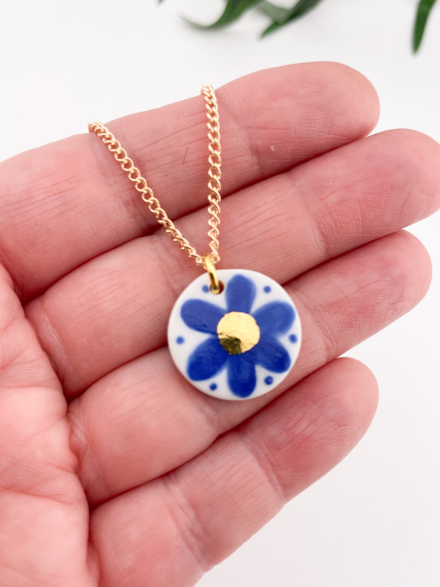 Hand painted blue flower pendant with gold centre