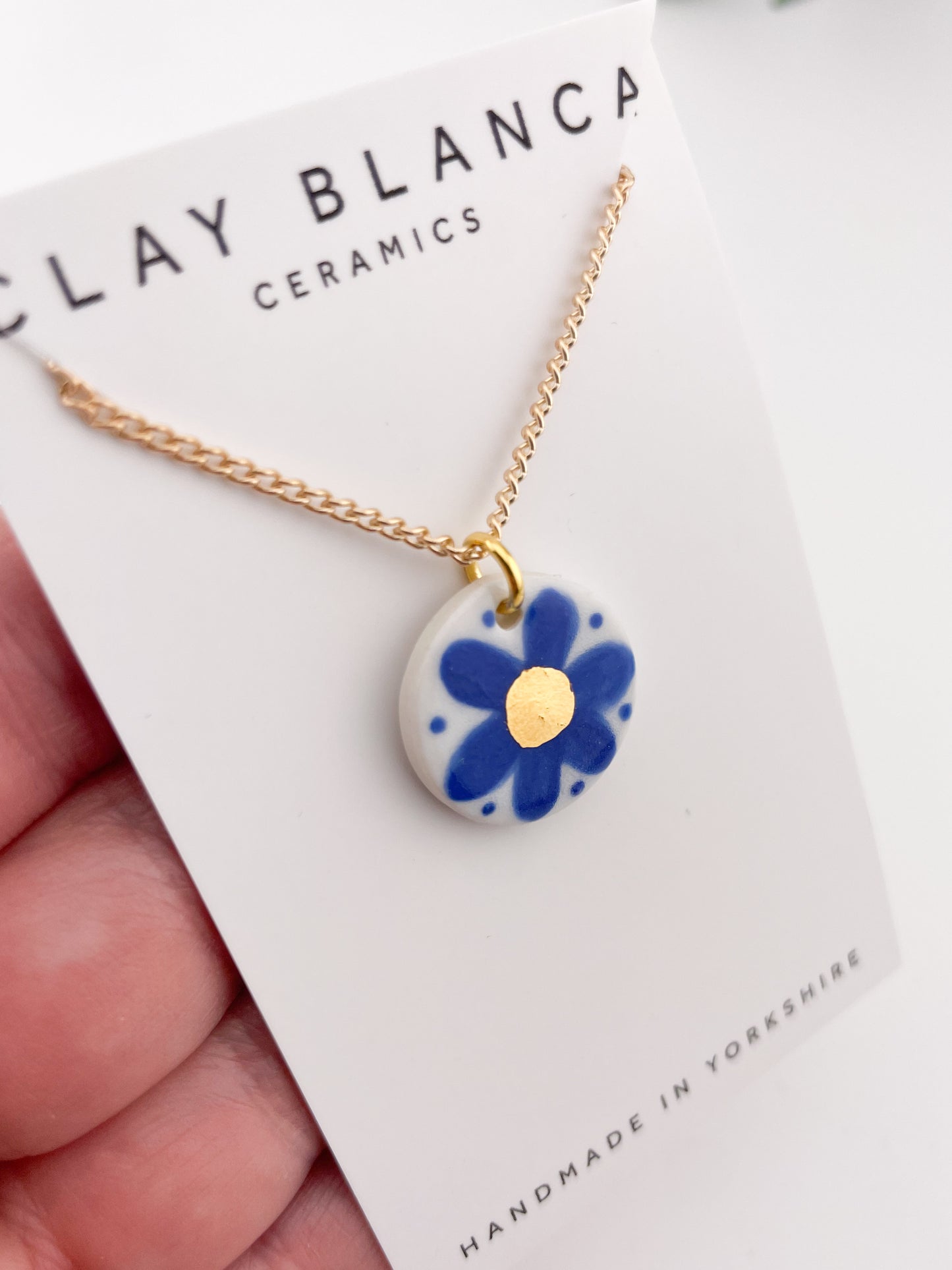 Hand painted blue flower pendant with gold centre