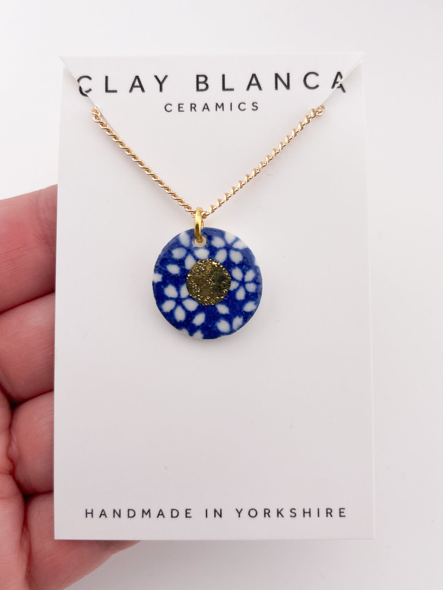 Blue Pendant with white flowers pattern & gold lustre centre