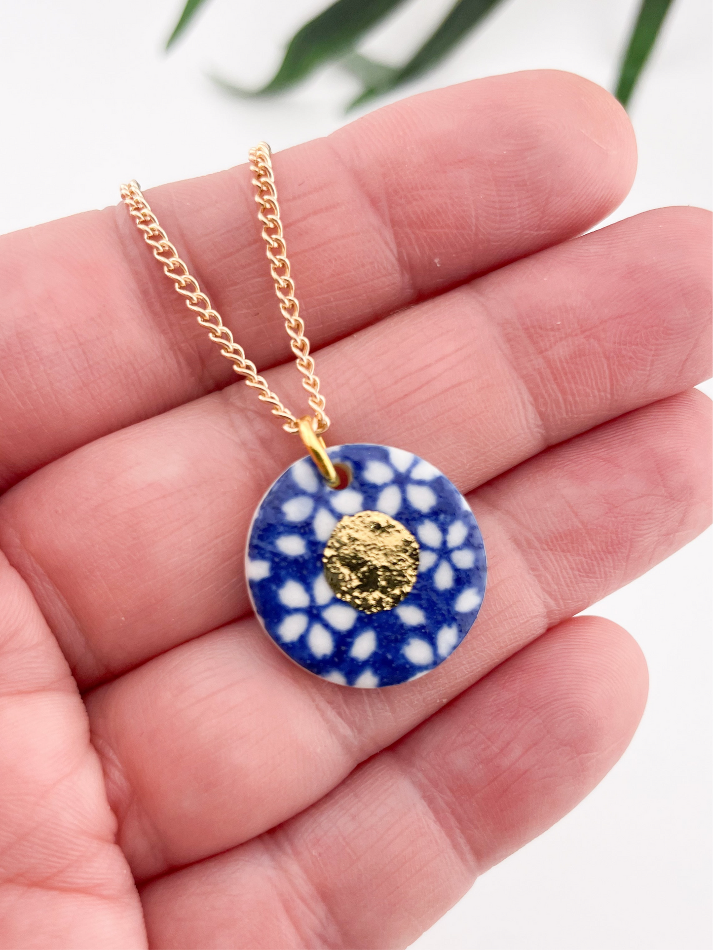 Blue Pendant with white flowers pattern & gold lustre centre