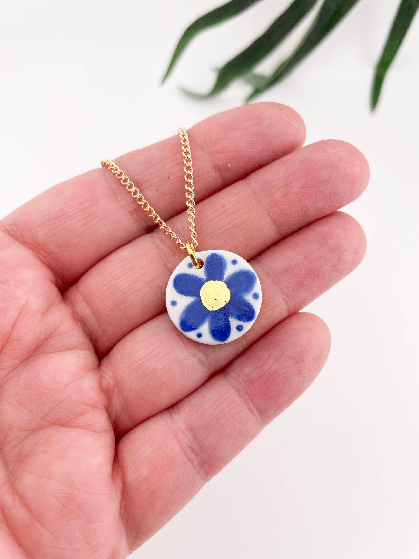 Hand painted blue flower pendant with gold centre