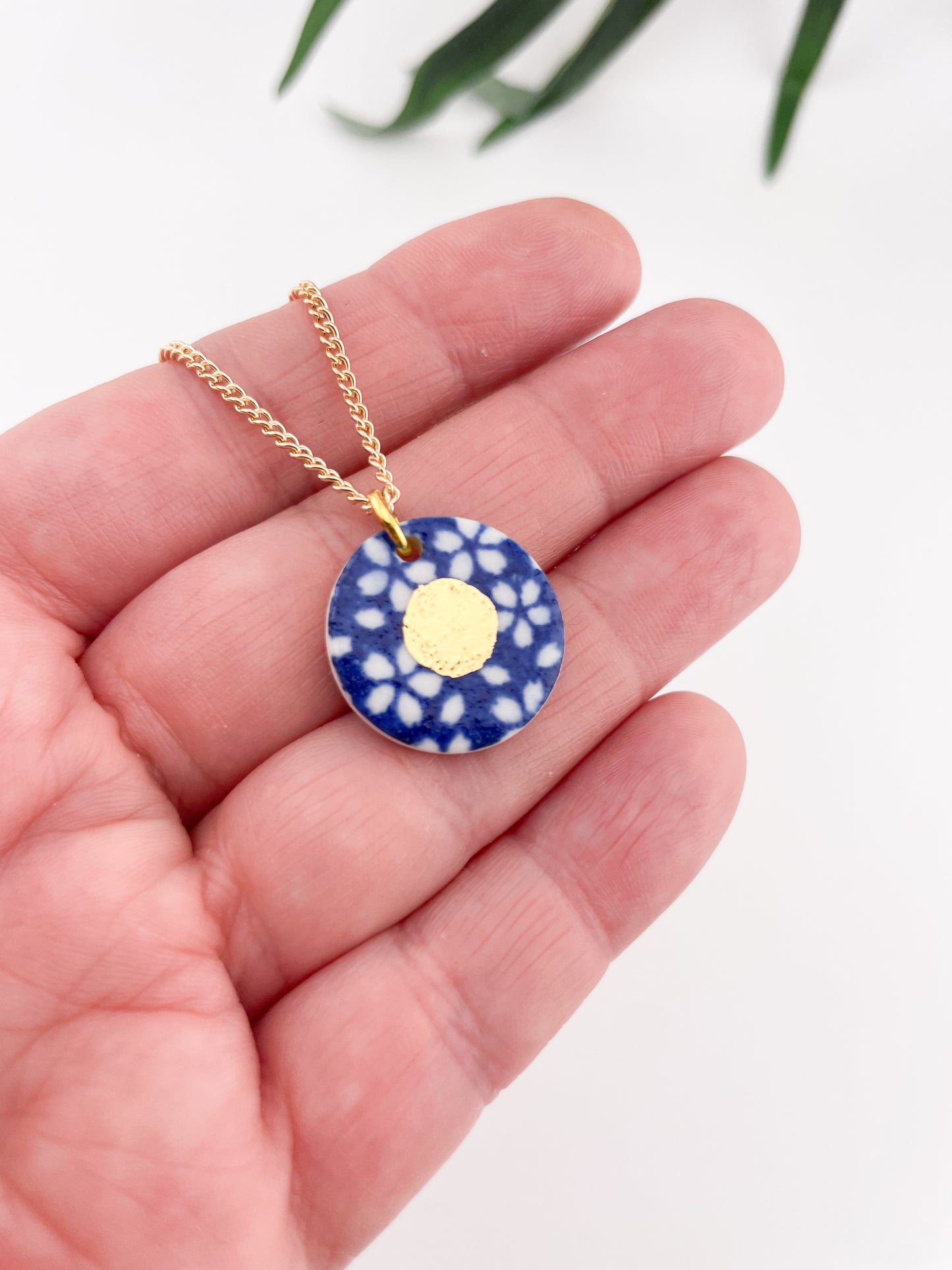 Blue Pendant with white flowers pattern & gold lustre centre