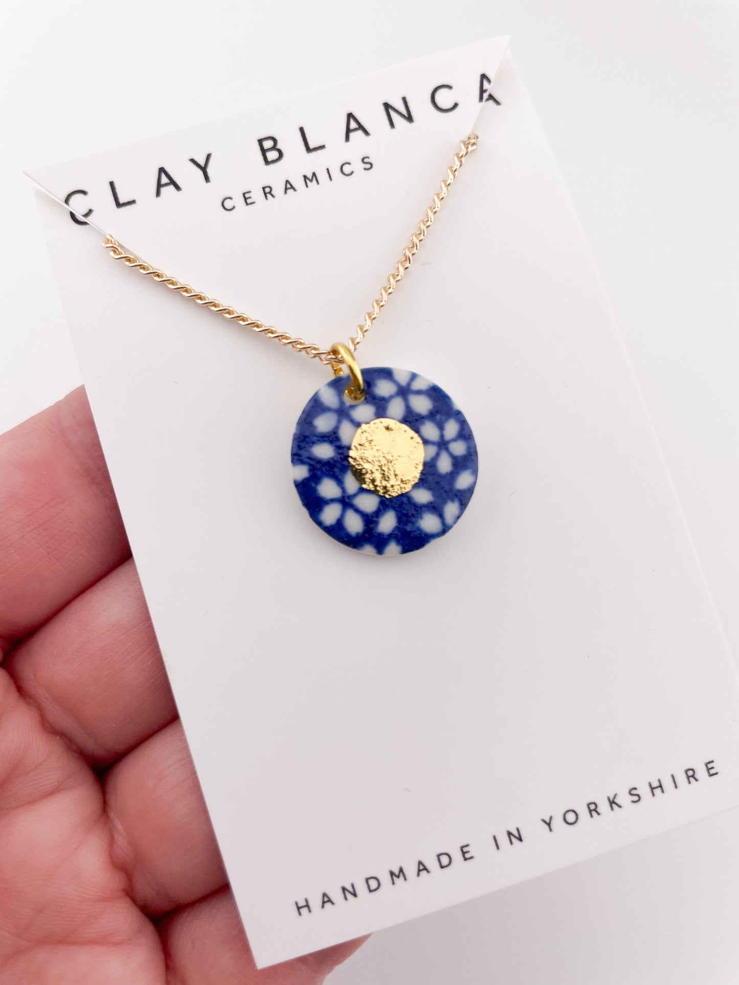 Blue Pendant with white flowers pattern & gold lustre centre