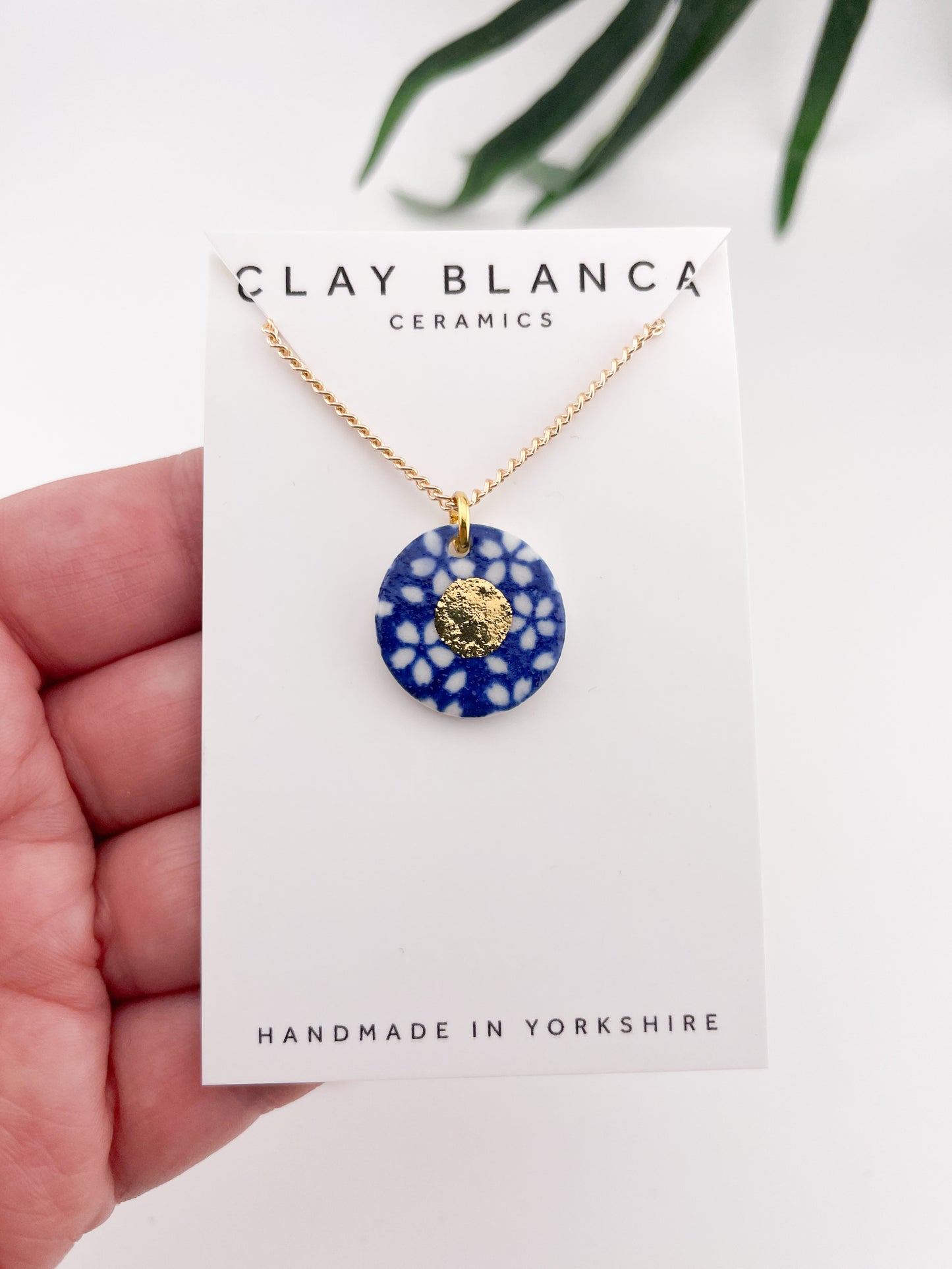 Blue Pendant with white flowers pattern & gold lustre centre