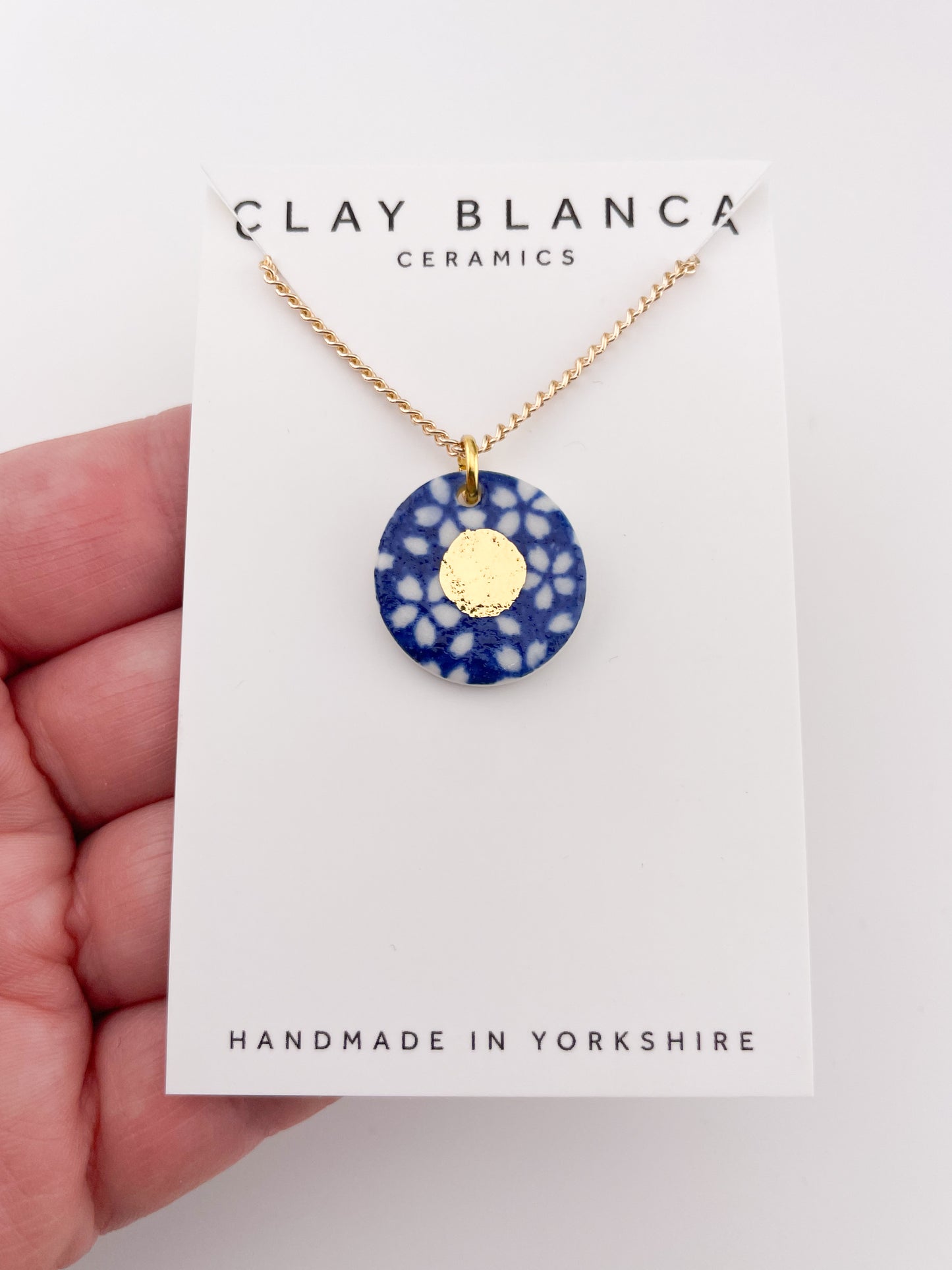 Blue Pendant with white flowers pattern & gold lustre centre