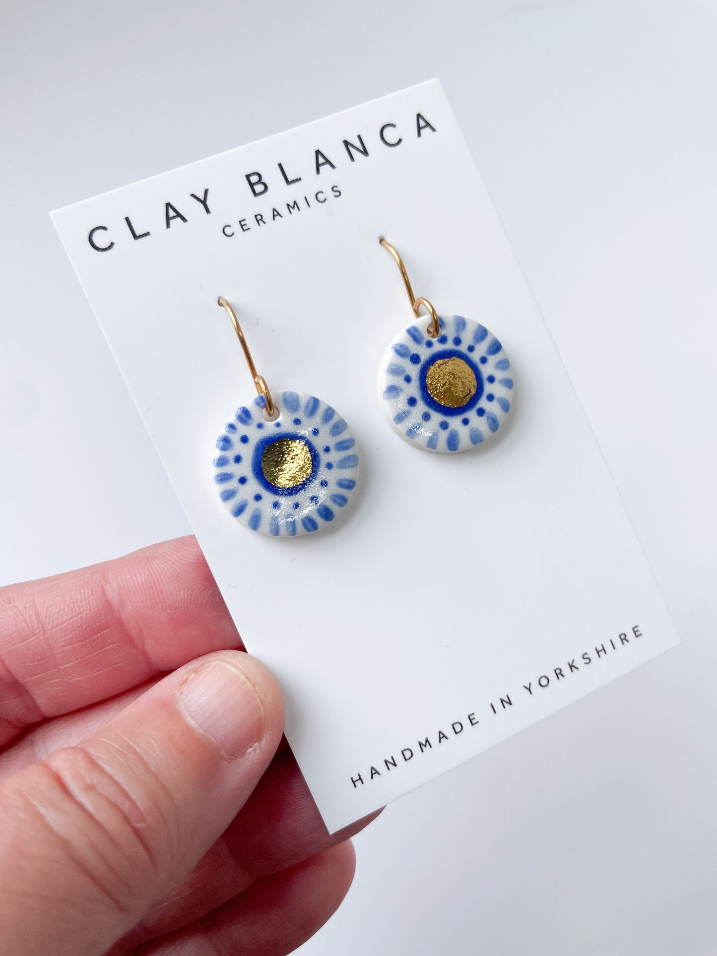 Hand painted white and blue dot earrings with gold lustre centre