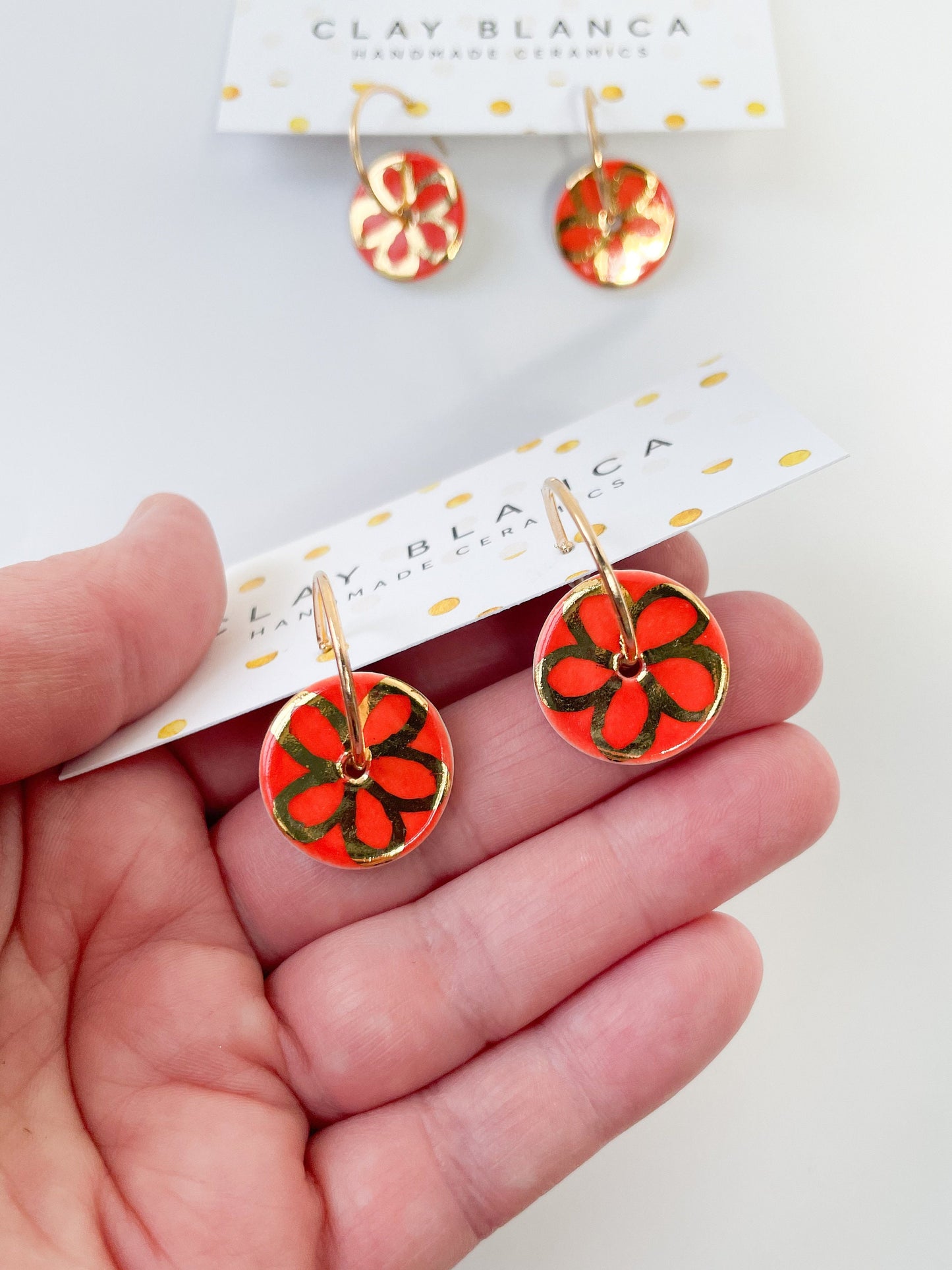 Round Orange earrings with gold flower design