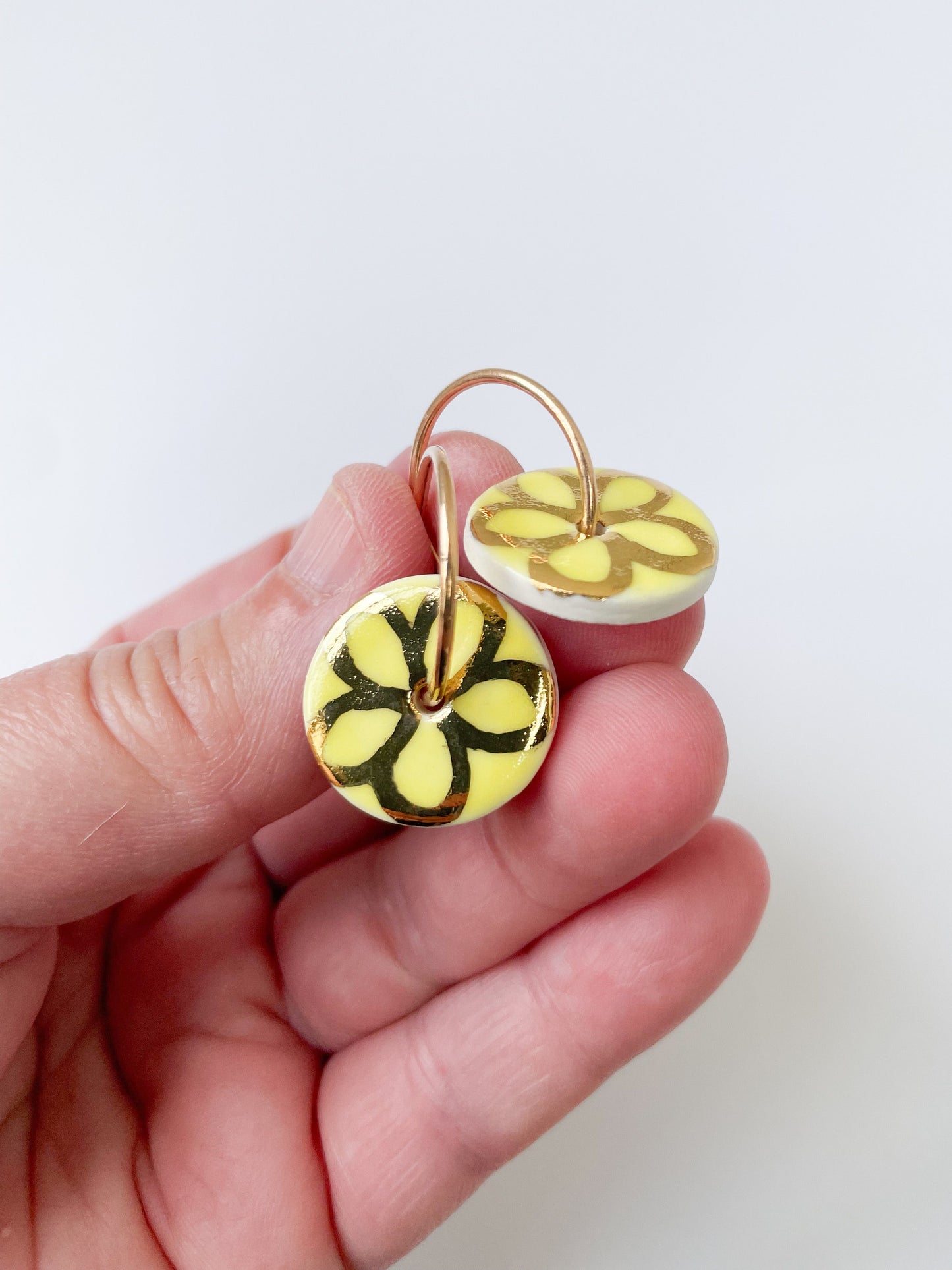 Round Yellow earring with gold flower design