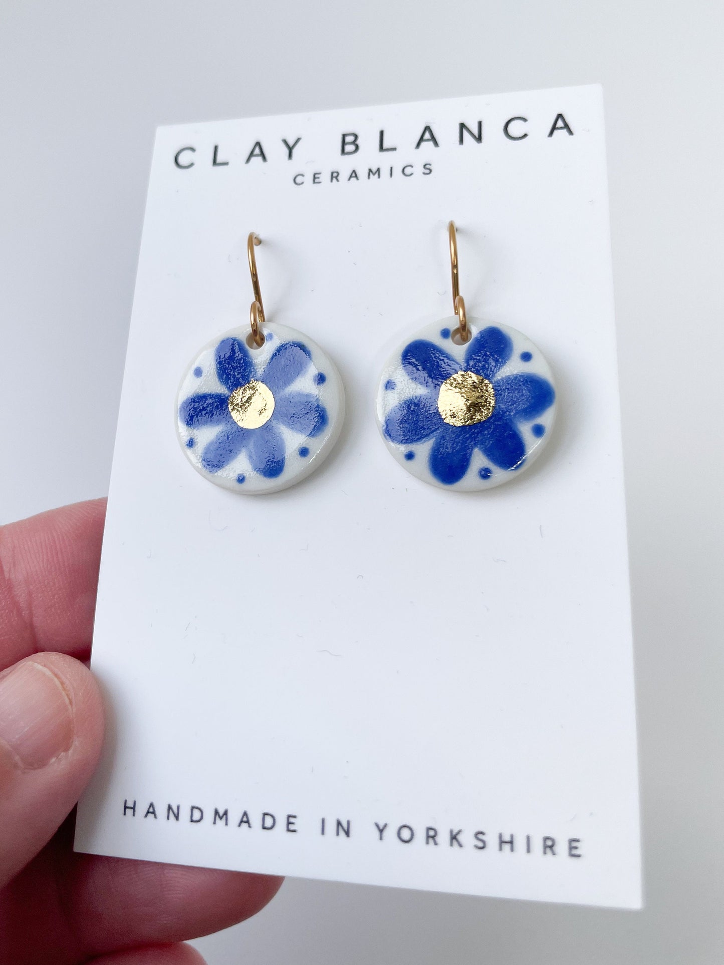 Hand painted blue flower earrings with gold centre