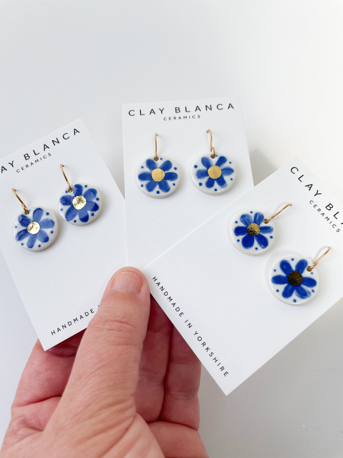 Hand painted blue flower earrings with gold centre