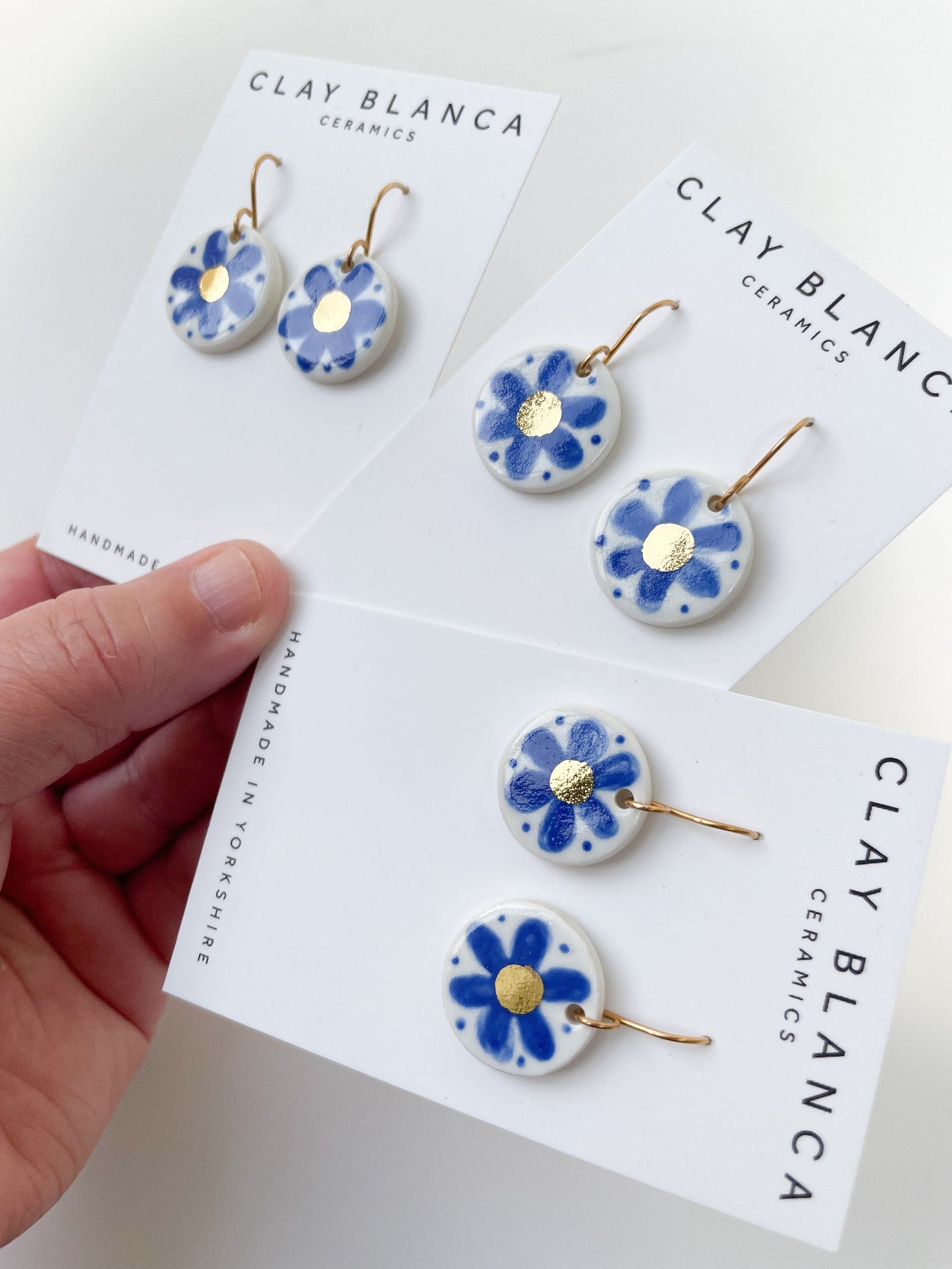 Hand painted blue flower earrings with gold centre