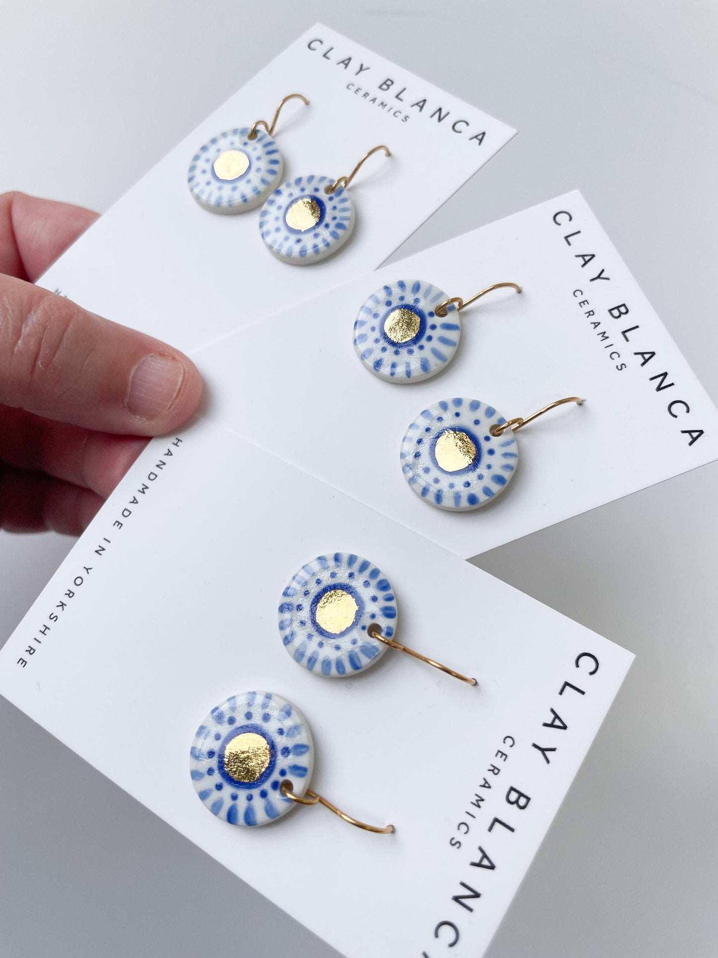 Hand painted white and blue dot earrings with gold lustre centre