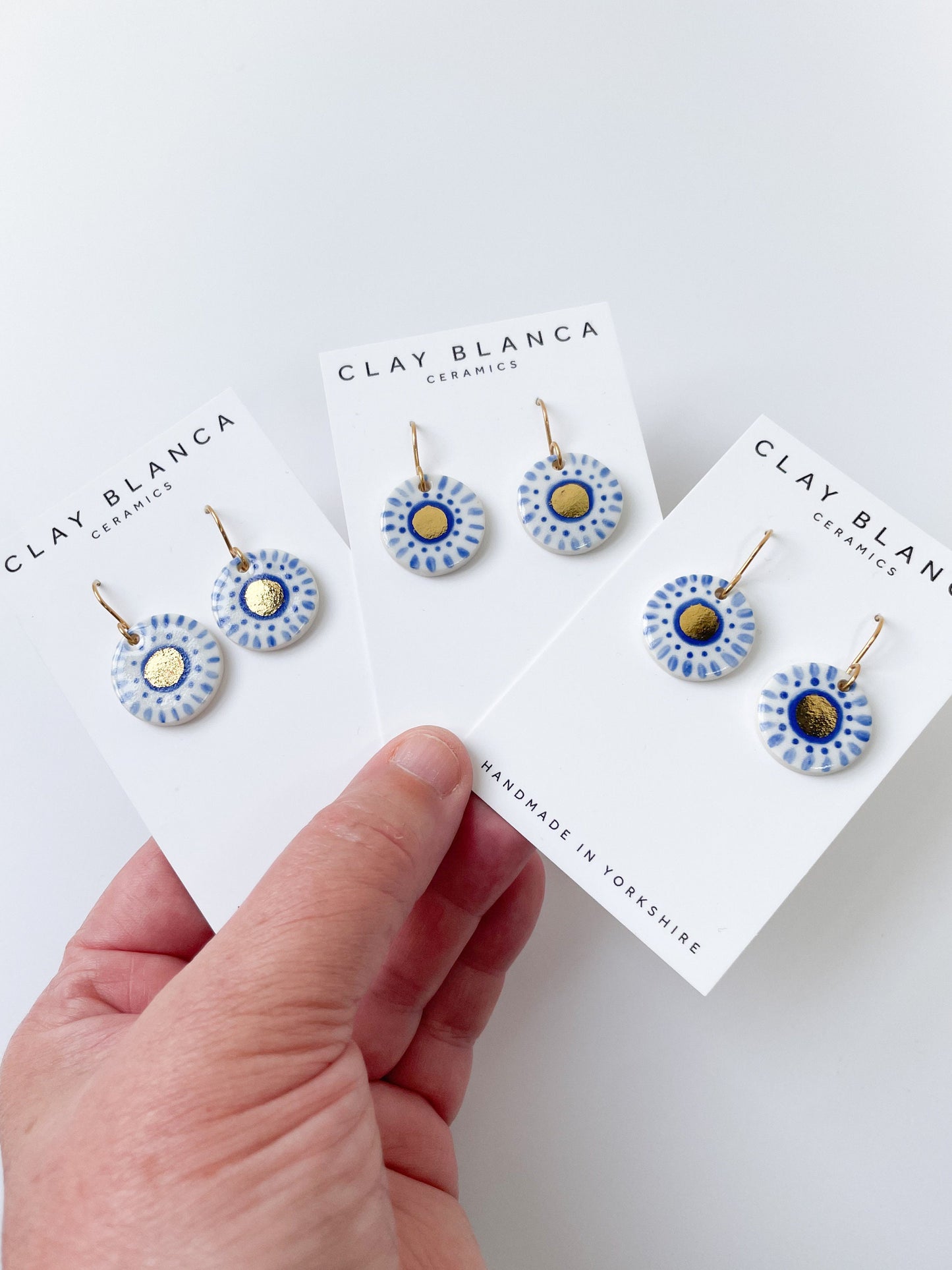 Hand painted white and blue dot earrings with gold lustre centre