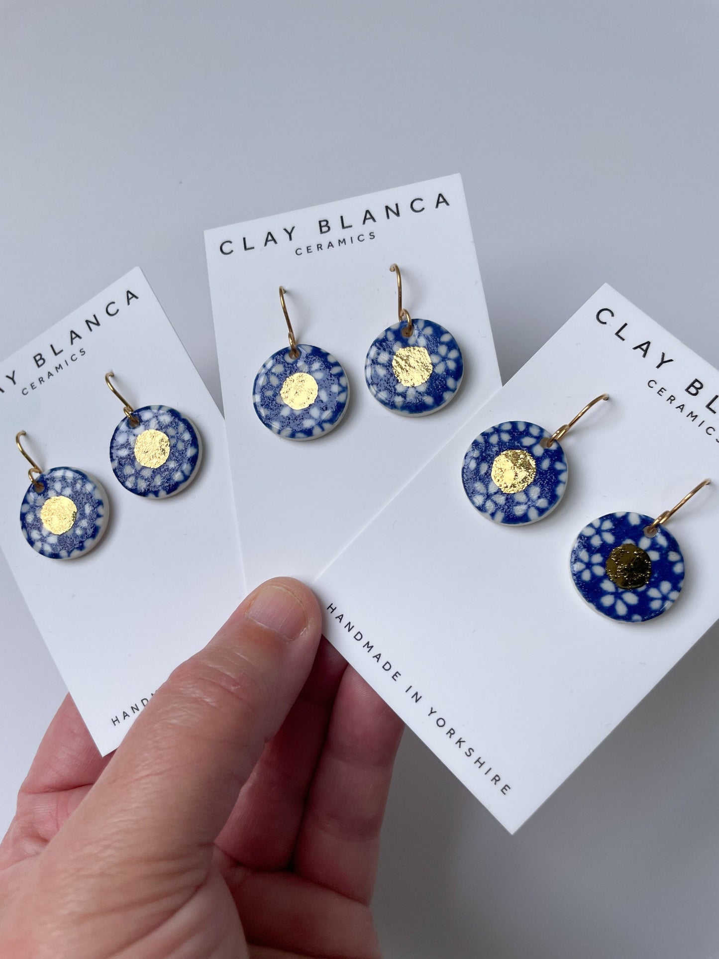 Blue earrings with white flowers pattern & gold lustre centre