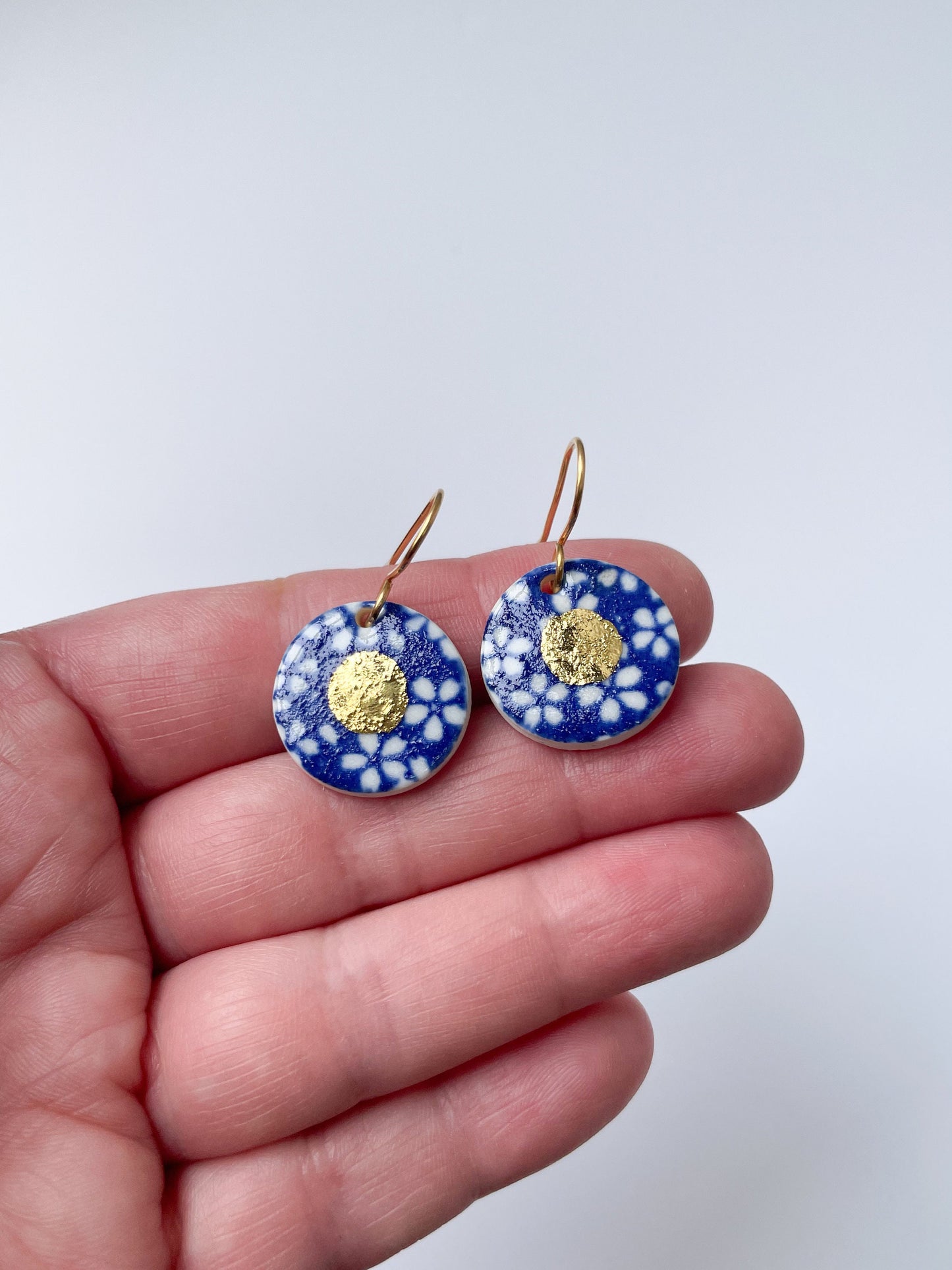 Blue earrings with white flowers pattern & gold lustre centre