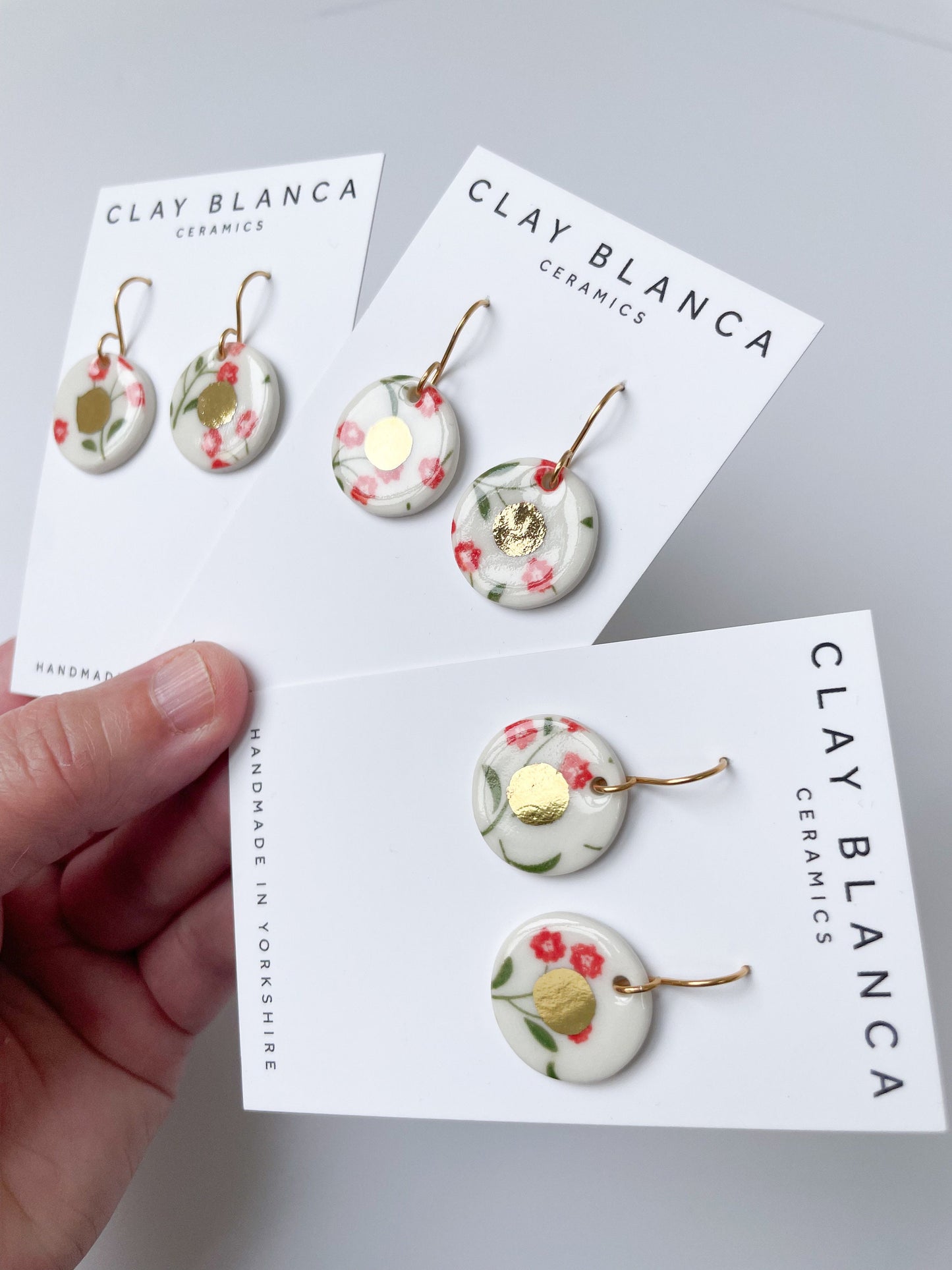 White round earrings with red flowers