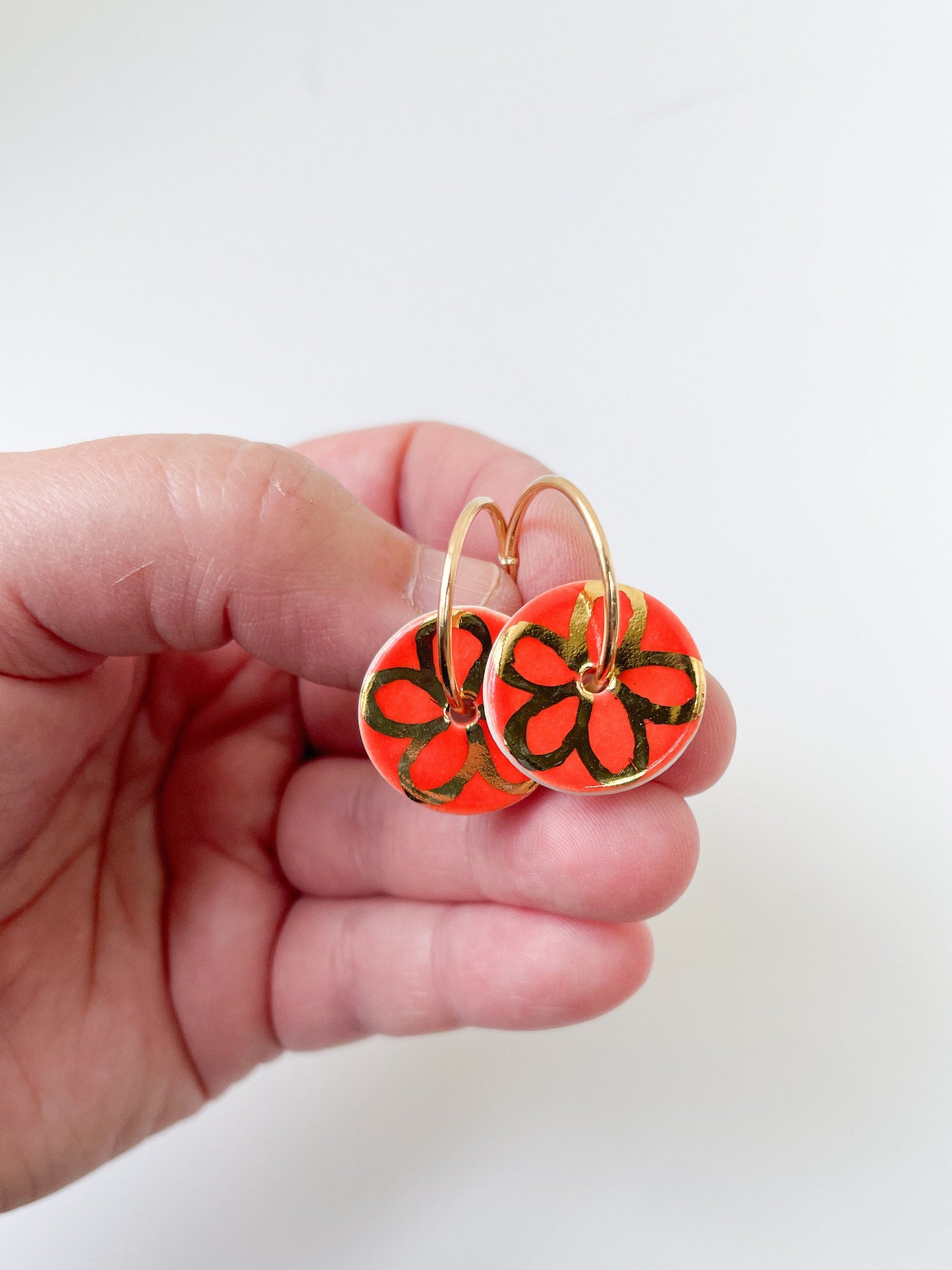 Round Orange earrings with gold flower design