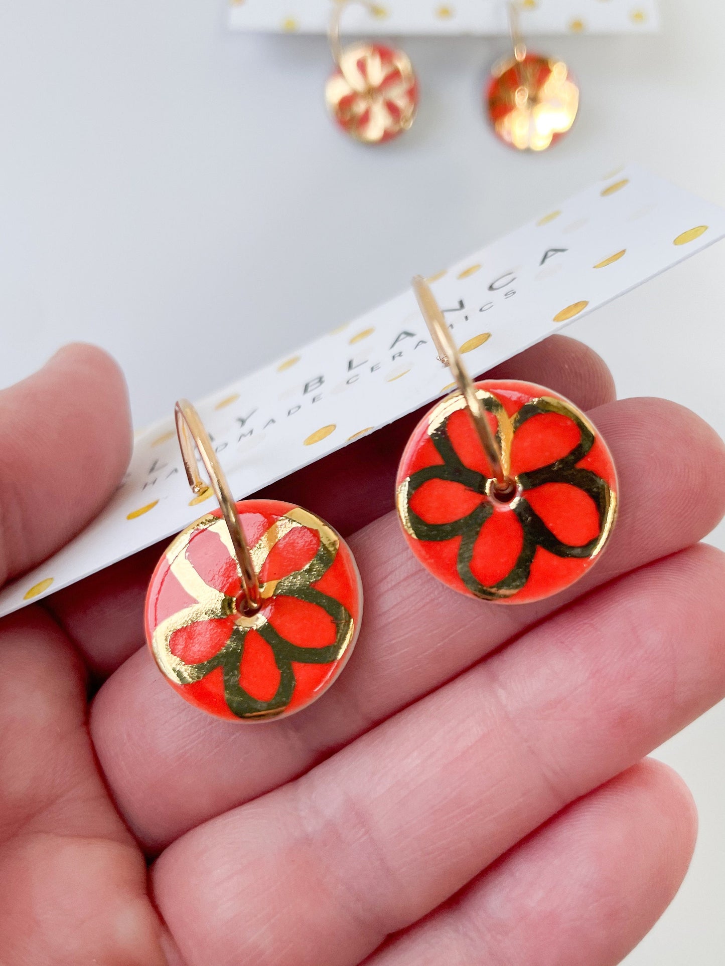 Round Orange earrings with gold flower design