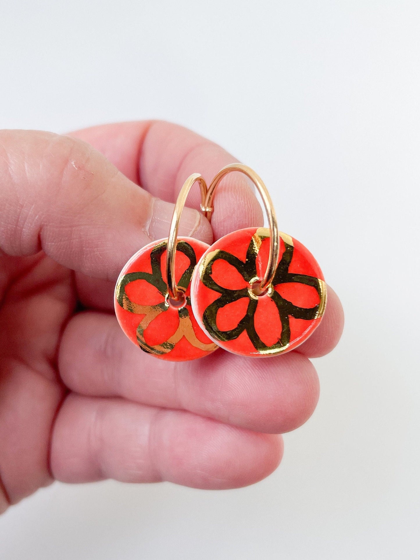 Round Orange earrings with gold flower design