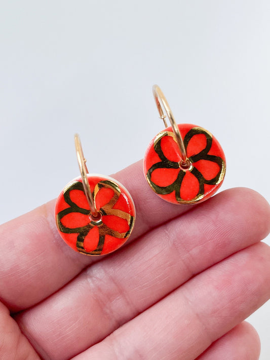 Round Orange earrings with gold flower design